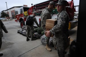 Staff Sgt. Richard Nielsen moves boxes to prepare for a flight to Haiti on Charleston AFB, Jan. 22. Firefighters will take different types of gear with them to deployed locations for different environmental hazards. These specific firemen will be providing fire protection for the aircraft at the airport in Haiti. Sergeant Nielsen is a firefighter with Shaw AFB, S.C. (U.S. Air Force photo/Senior Airman Katie Gieratz)(RELEASED)