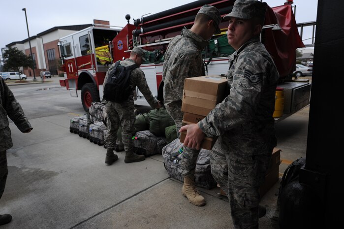 Staff Sgt. Richard Nielsen moves boxes to prepare for a flight to Haiti on Charleston AFB, Jan. 22. Firefighters will take different types of gear with them to deployed locations for different environmental hazards. These specific firemen will be providing fire protection for the aircraft at the airport in Haiti. Sergeant Nielsen is a firefighter with Shaw AFB, S.C. (U.S. Air Force photo/Senior Airman Katie Gieratz)(RELEASED)