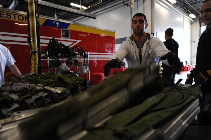 Staff Sgt. Zack Silvis loads a cot onto a pallet at Charleston AFB, Jan. 22. There is a large group of firefighters from different bases around the U.S. that are going to Haiti to provide fire protection for the aircraft on the ground at the airport. Sergeant's Silvis is a firefighter from Dover AFB, Del. (U.S. Air Force photo/Senior Airman Katie Gieratz)(RELEASED)