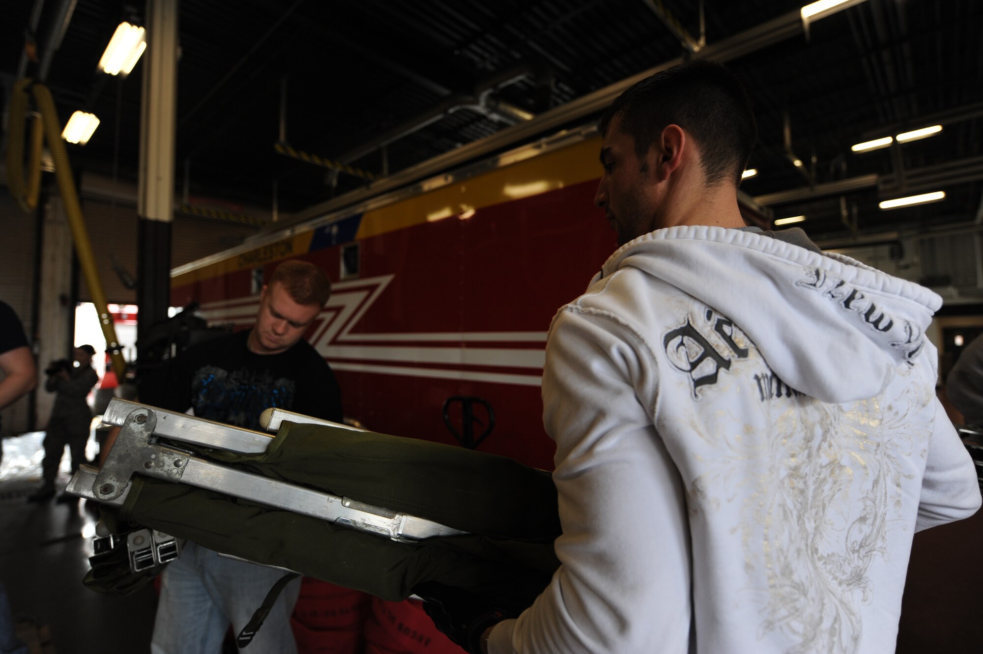 Staff Sergeants Zack Silvis and Chad James prepare to load cots onto a pallet at Charleston AFB, Jan. 22. There is a large group of firefighters from different bases around the U.S. that are going to Haiti to provide fire protection for the aircraft on the ground at the airport. Sergeant's Silvis and James are both firefighters, Sergeant Silvis is from Dover AFB, Del., and Sergeant James is with the Elmendorf AFB, Alaska, fire department. (U.S. Air Force photo/Senior Airman Katie Gieratz)(RELEASED) 