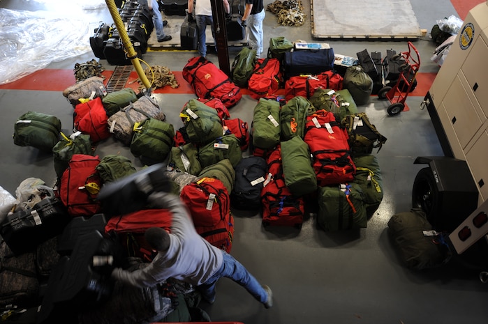 Senior Airman Nicholas Torraco moves bags on Charleston AFB, Jan. 22. Airman Torraco is with a group of firefighters from different bases across the United States that are going to Haiti to support in the humanitarian relief effort. Airman Torraco is a firefighter with McGuire AFB, N.J. (U.S. Air Force photo/Senior Airman Katie Gieratz)(RELEASED)