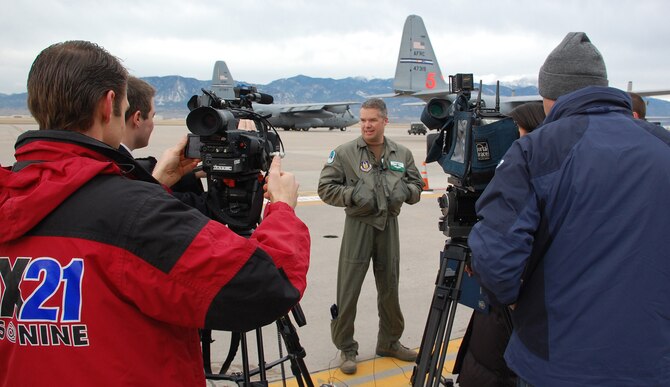 Maj. Brad James, 731st Airlift Squadron pilot, meets with Colorado Springs media before departing Peterson Air Force Base Jan. 22 in support of Operation Coronet Oak. Two C-130 Hercules and approximately 50 Air Force Reservists from the 302nd Airlift Wing left Colorado to fly missions out of Puerto Rico in support of Haitian relief efforts. (U.S. Air Force photo/Tech. Sgt. Daniel Butterfield)