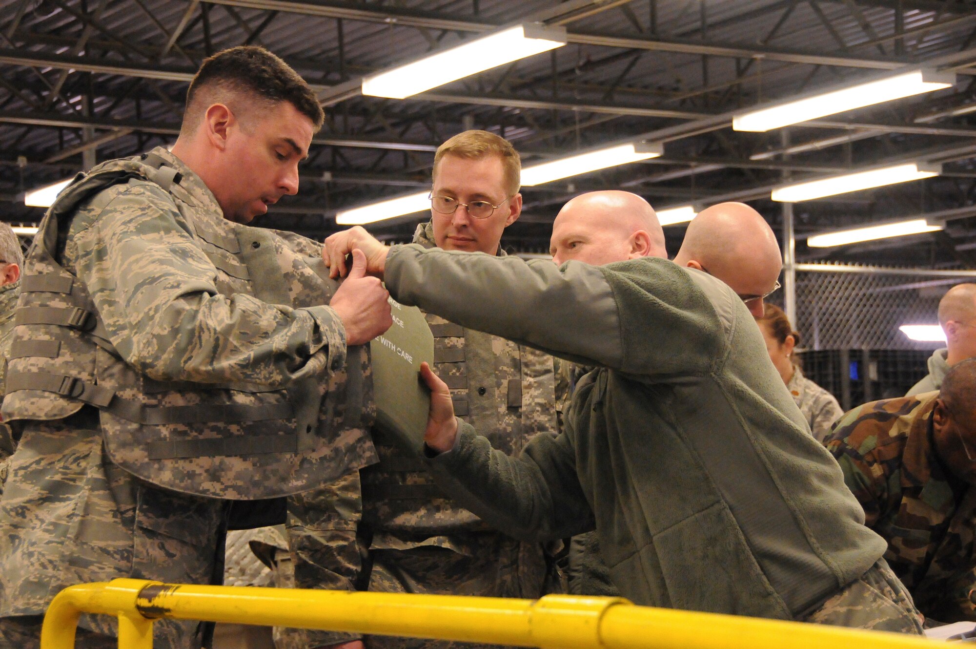 Members of the 123rd Airlift Wing are issued body armor Jan. 21, 2010, at the Kentucky Air National Guard Base in Louisville, Ky., in preparation for a flight to the Dominican Republic on Jan. 22, 2010, as part of earthquake relief efforts in Haiti. Three C-130s and approximately 45 Kentucky Air National Guardsmen are deploying to establish an air cargo hub at Maria Montez International Airport that will be responsible for controlling incoming aircraft, offloading relief supplies and staging them for further movement into Haiti. (U.S. Air Force photo by Tech. Sgt. Dennis Flora)