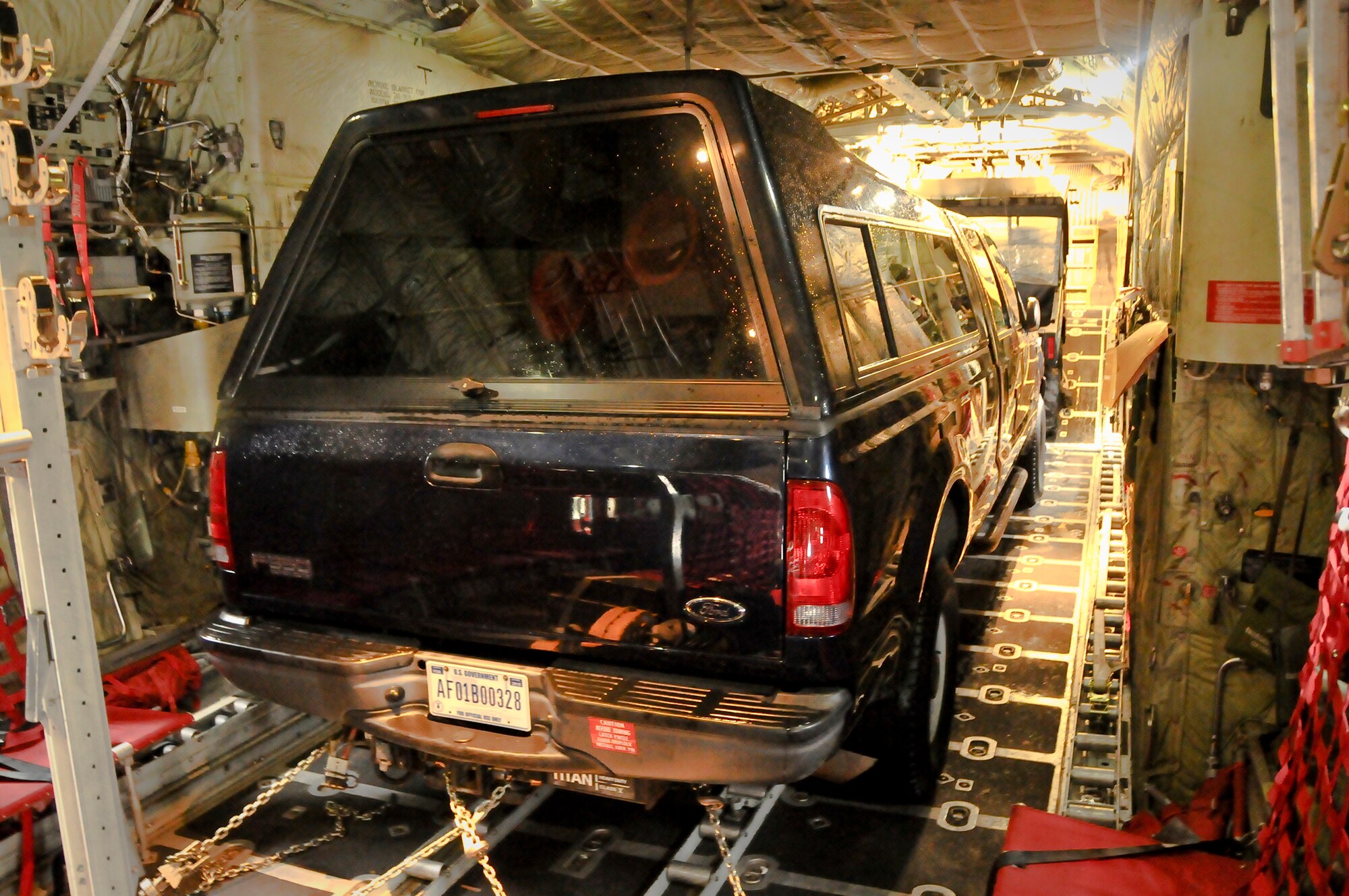 A pick-up truck is loaded onto a C-130 aircraft at the Kentucky Air National Guard Base in Louisville, Ky., on Jan. 21, 2010, for a flight to the Dominican Republic as part of earthquake relief efforts in Haiti. Three C-130s left from the unit Jan. 22, 2010 along with approximately 45 Kentucky Air National Guardsmen to establishing an air cargo hub at Maria Montez International Airport that will be responsible for controlling incoming aircraft, offloading relief supplies and staging them for further movement into Haiti. (U.S. Air Force photo by Tech. Sgt. Dennis Flora)