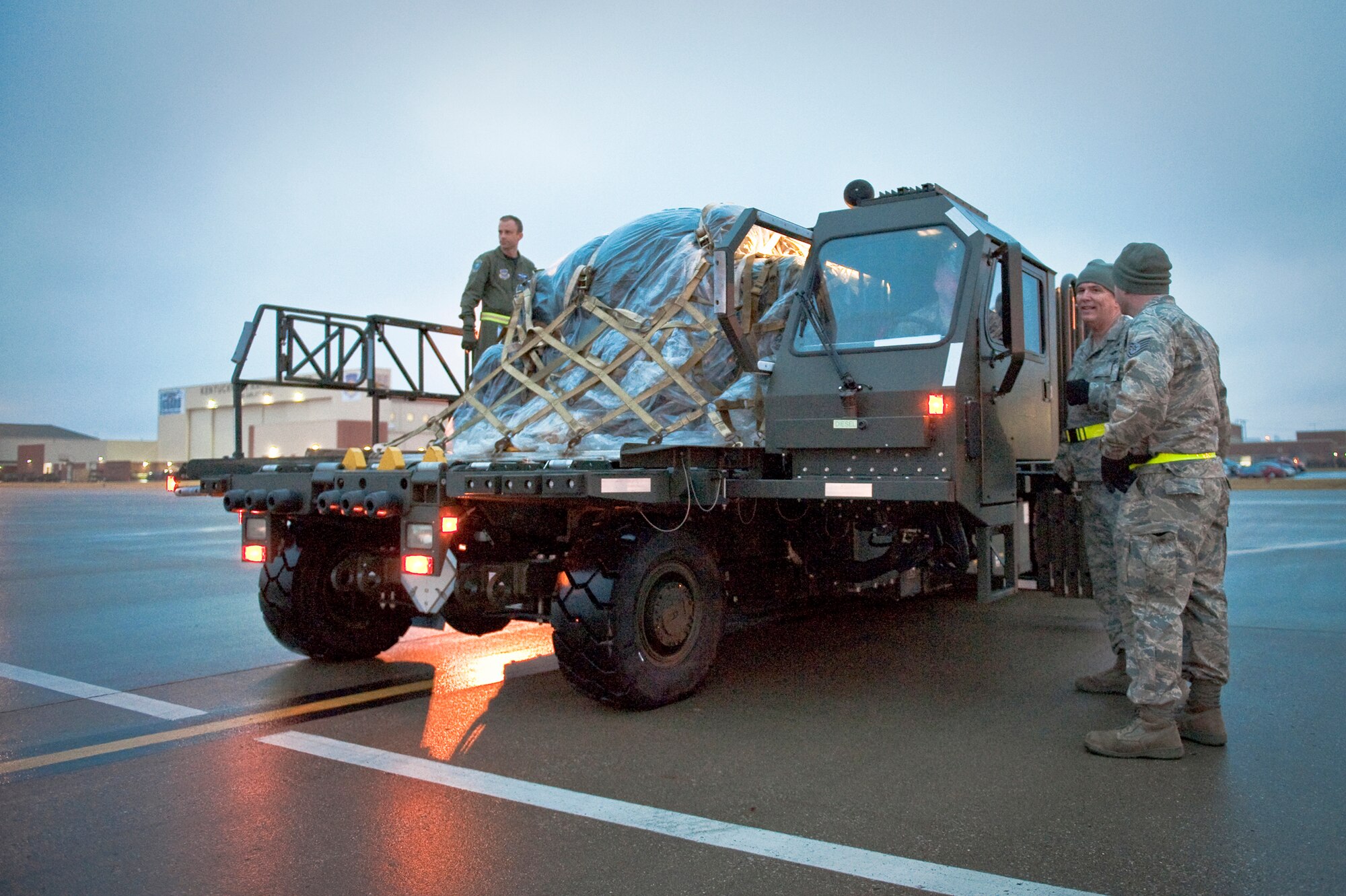 Members of the 123rd Airlift Wing prepare to load equipment and relief supplies onto a C-130 aircraft at the Kentucky Air National Guard Base in Louisville, Ky., on Jan. 22, 2010, for a flight to the Dominican Republic as part of earthquake relief efforts in Haiti. The flight was one of three C-130s that left from the unit Jan. 22, along with approximately 45 Kentucky Air National Guardsmen. The troops are establishing an air cargo hub at Maria Montez International Airport that will be responsible for controlling incoming aircraft, offloading relief supplies and staging them for further movement into Haiti. (U.S. Air Force photo by Maj. Dale Greer)