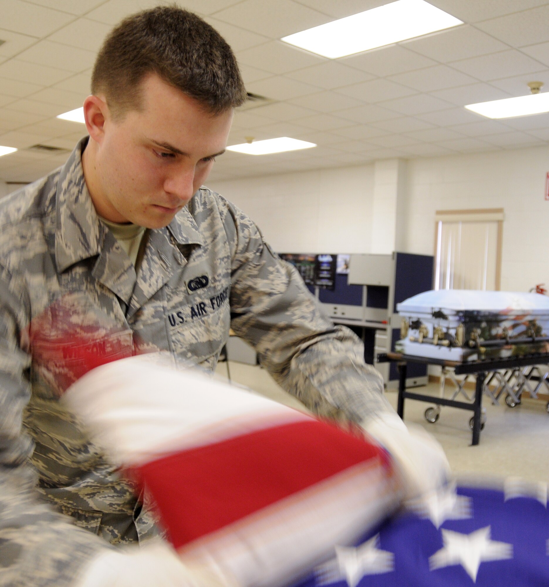 EGLIN AIR FORCE BASE, Fla. – Airman 1st Class Paul Wilson, Honor Guard, practice the ceremonial folding of the flag, Jan. 20. “Working in a support role Airmen can lose their sense of perspective as to why they serve,” said Senior Master Sgt. Thomas Walker, 96th Air Base Wing, on what it means to serve in the honor guard.  “Being able to step outside the career field and daily, mundane taskings and serve a higher purpose gives them a greater sense of duty, commitment and perspective that pays huge dividends when they return to their normal job.  Ask any Airmen who has ever served in the Honor Guard and they will tell you it was one of the greatest experiences of their career (whether they were volunteers or volun"tolds").  The sense of fulfillment, job satisfaction and pride are unmatched.”   The next honor guard rotation begins Feb. 1 through July 31.  Deadline to sign-up is Jan. 25.  To get involved and volunteer contact your first sergeant or chief. (U.S. Air Force photo/ Airman 1st Class Anthony Jennings)