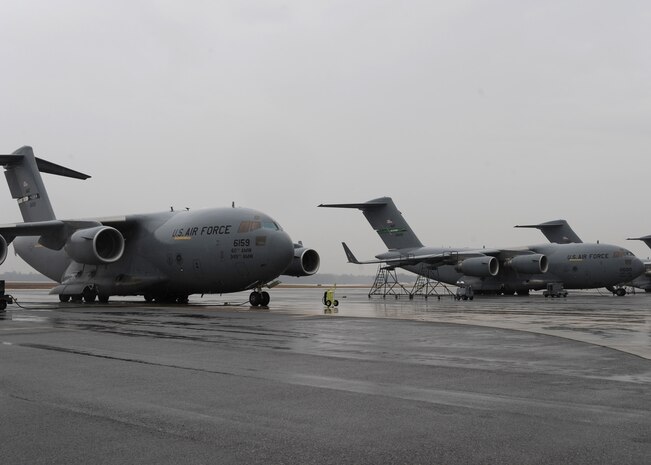 Several C-17 aircraft sit on the Charleston AFB flightline here Jan. 21. The planes were from bases such as Elmendorf, Alaska, Travis, Calif., Hickam, Hawaii and McChord, Wash. The Air Force's airlift capability enables the U.S. to respond immediately to any disaster domestically or worldwide. the U.S. is the only country with an aircraft fleet capable of providing this type of response.  (U.S. Air Force photo/Senior Airman Katie Gieratz)(RELEASED)

