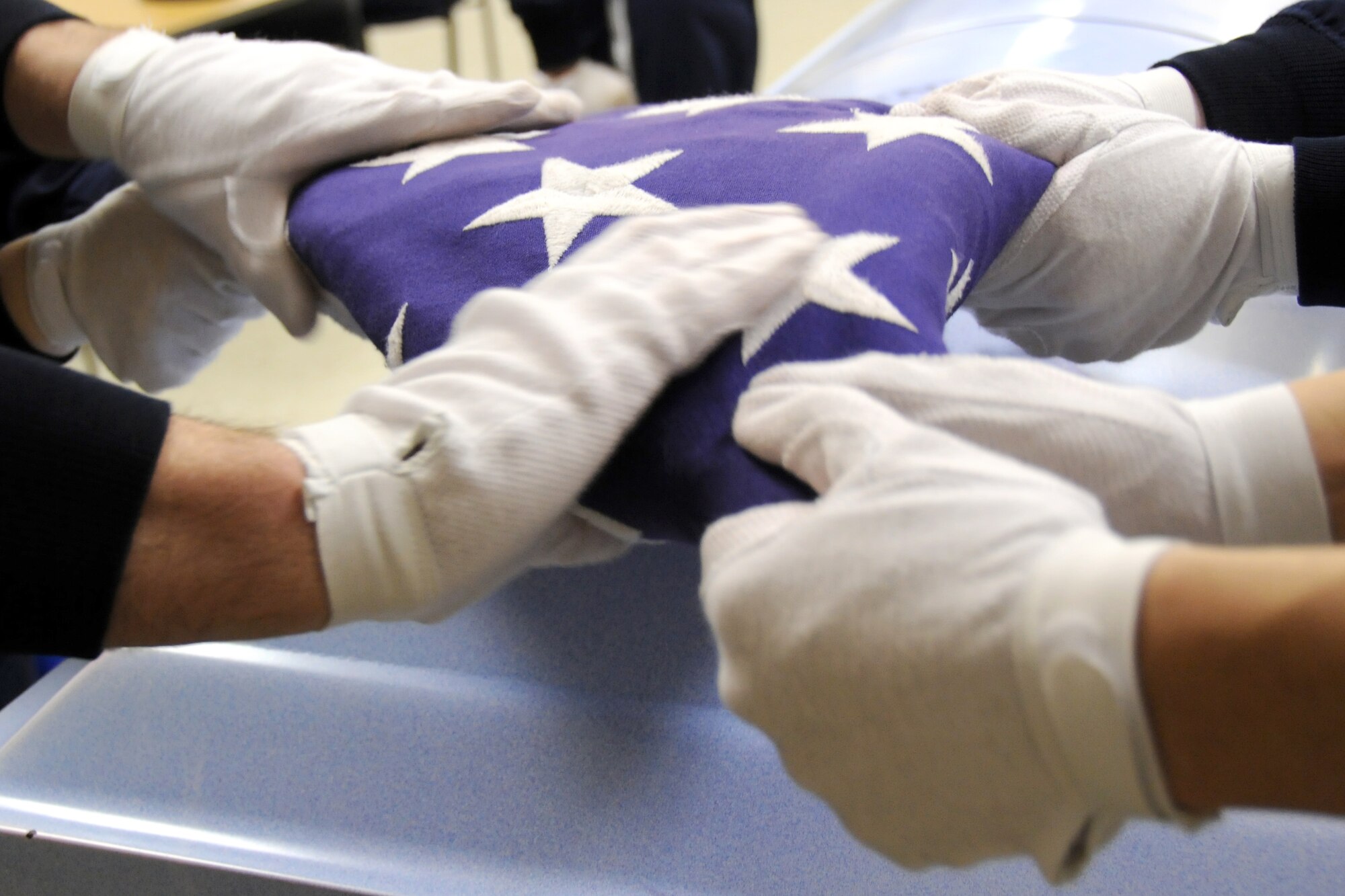 EGLIN AIR FORCE BASE, Fla. –  Members of Eglin’s Honor Guard practice the ceremonial folding of the flag for military funerals, Jan. 20. “Working in a support role Airmen can lose their sense of perspective as to why they serve,” said Senior Master Sgt. Thomas Walker, 96th Air Base Wing, on what it means to serve in the honor guard.  “Being able to step outside the career field and daily, mundane taskings and serve a higher purpose gives them a greater sense of duty, commitment and perspective that pays huge dividends when they return to their normal job.  Ask any Airmen who has ever served in the Honor Guard and they will tell you it was one of the greatest experiences of their career (whether they were volunteers or volun"tolds").  The sense of fulfillment, job satisfaction and pride are unmatched.”   The next honor guard rotation begins Feb. 1 through July 31.  Deadline to sign-up is Jan. 25.  To get involved and volunteer contact your first sergeant or chief. (U.S. Air Force photo/ Airman 1st Class Anthony Jennings)