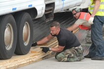 A Federal Aviation Administration (FAA) mobile air traffic control tower is being loaded on to a Russian owned Antonov An-124 aircraft bound for the Port Au Prince Airport. The tower will serve as the main tower for the airport. Tech Sgt. Jake Teufel and Staff Sgt. Ryan Snyder, 914TH Maintenance Squadron, Niagra Falls, N.Y. assist members of the Russian crew with approach shoring.  (Air Force photo/Master Sgt. Chance Babin)
