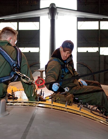 Staff Sgt. Dan Louden, 60th Maintenance Squadron, and Staff Sgt. Brent Dost, 349th MXS, tighten more than 8,000 fasteners on a C-5C Galaxy. (U.S. Air Force photo/Lt. Col. Robert Couse-Baker)