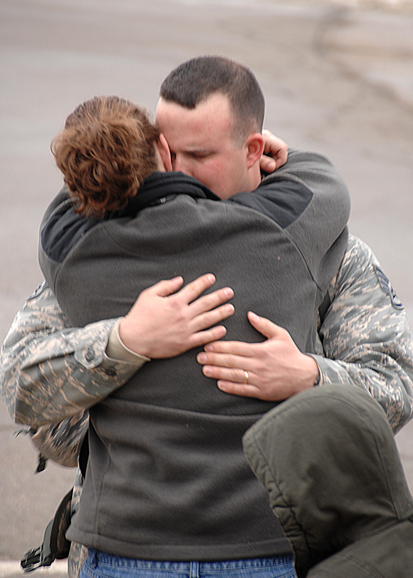 Staff Sgt. Mark Kambell hugs his wife Clarissa, before climbing on the bus to be transported out to the aircraft to depart for Southwest Asia. (U.S. Air Force photos by Ben Stasser)