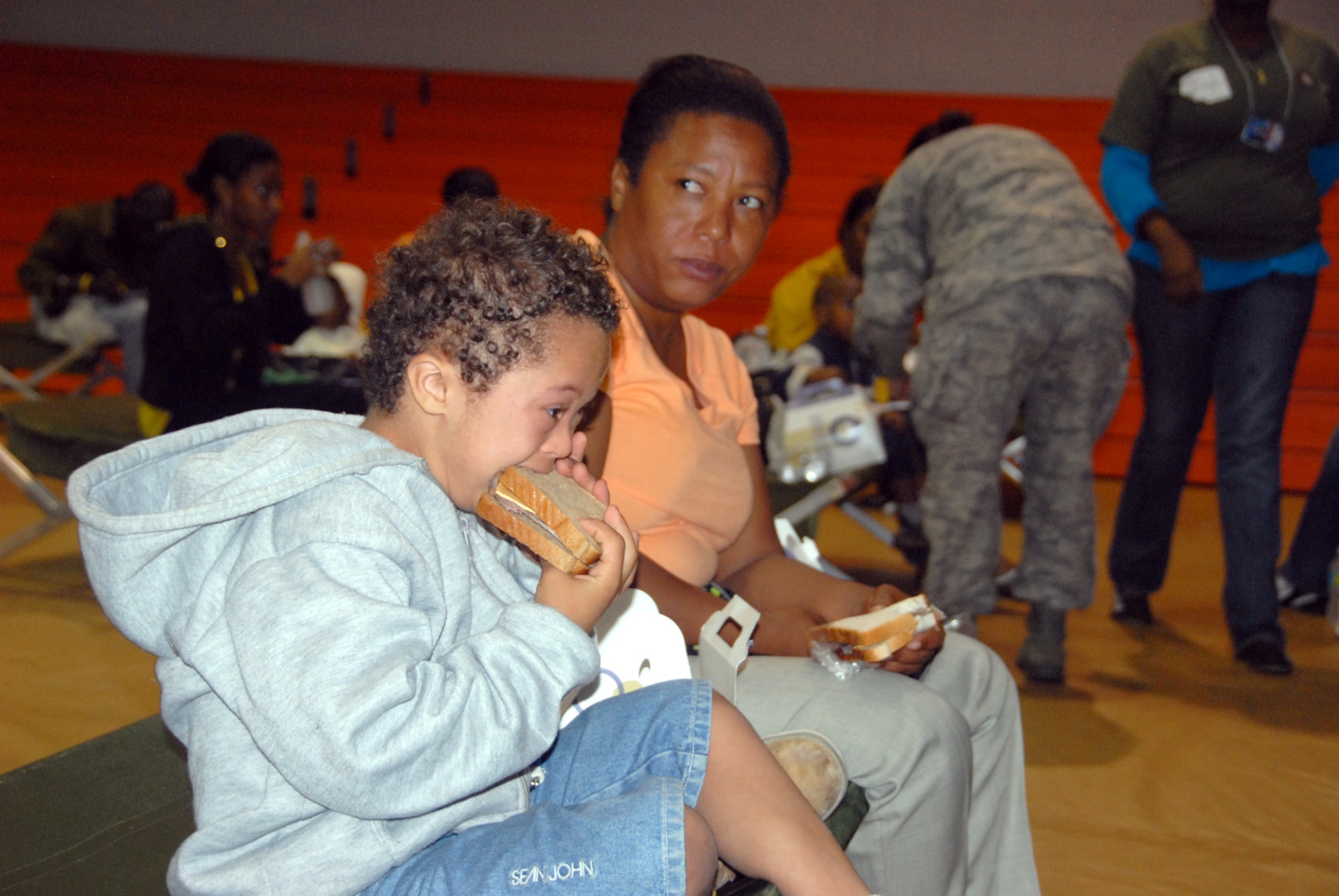 A young Haitian boy enjoys a sandwich from a box lunch prepared by the 482nd Services Sqaudron, Homestead Air Reserve Base, Fla. The 482nd is preparing 500-800 box lunches a day in support of Operation Unified Response. (Air Force photo/Master Sgt. Chance Babin)