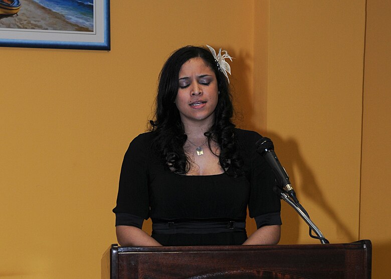 Airman 1st Class Colette Thomas, 31st Medical Support Squadron, sings "Lift Every Voice and Sing," also known as the Black National Anthem, during the Martin Luther King Jr. observance dinner held Jan. 20, 2010 at Aviano Air Base, Italy.  The song, originally written as a poem by James Weldon Johnson, was later set to music by his brother John Rosamond Johnson.  It was first performed as part of a celebration to honor President Lincoln's birthday in 1900. (U.S. Air Force photo/Senior Airman Tabitha M. Mans)