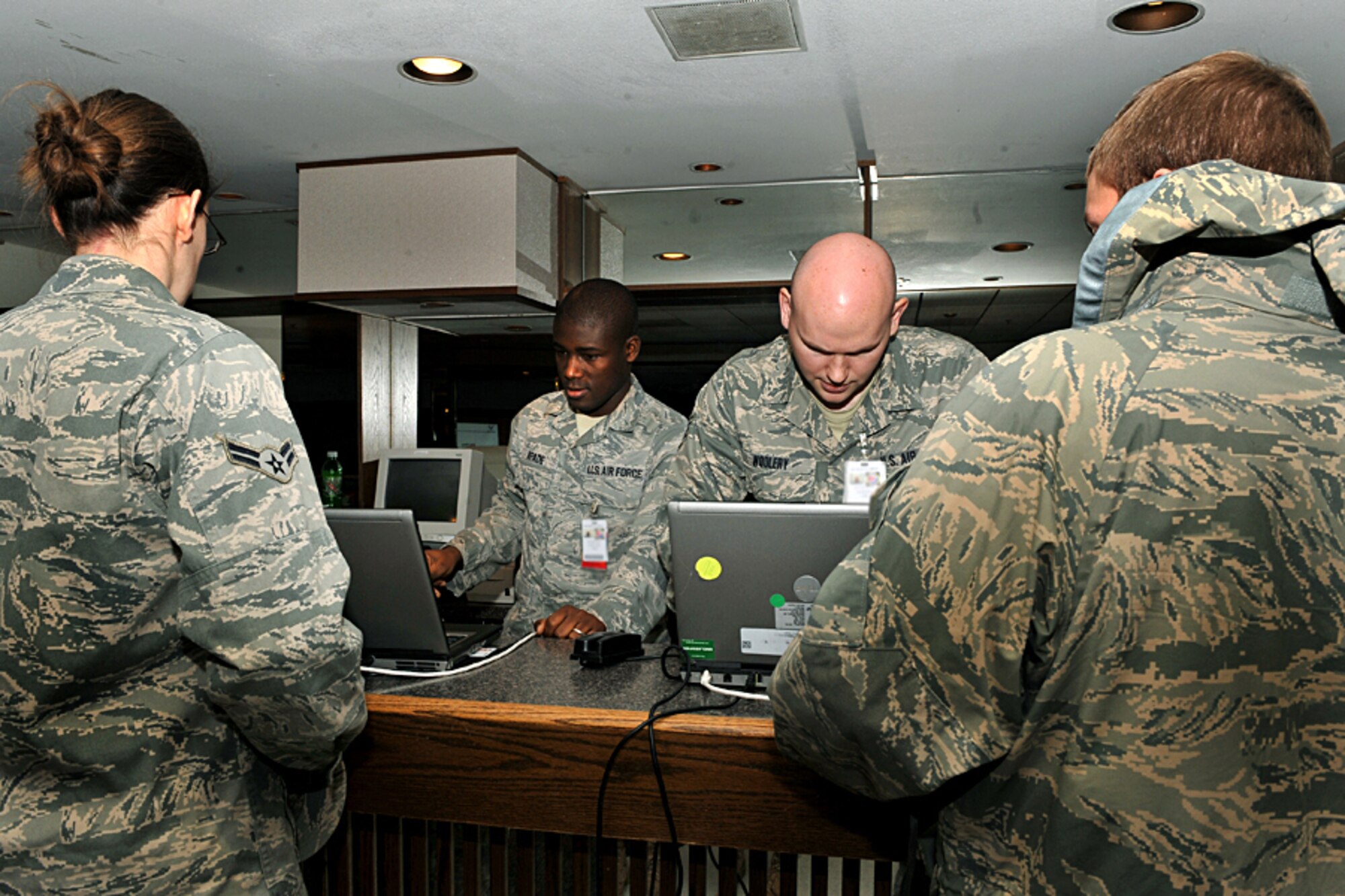 OFFUTT AIR FORCE BASE, Neb. - Senior Airman Krist Kpade and Staff Sgt. David Woolery, both with the 55th Medical Support Squadron, check in members of Team Offutt during a Point of Distribution exercise Jan. 21 at the community center here. More than 1,000 active-duty personnel processed through the center to test the 55th Wing's ability to respond to a public health emergency.  Many received their H1N1 inoculation during the event. U.S. Air Force photo by Charles Haymond
 
