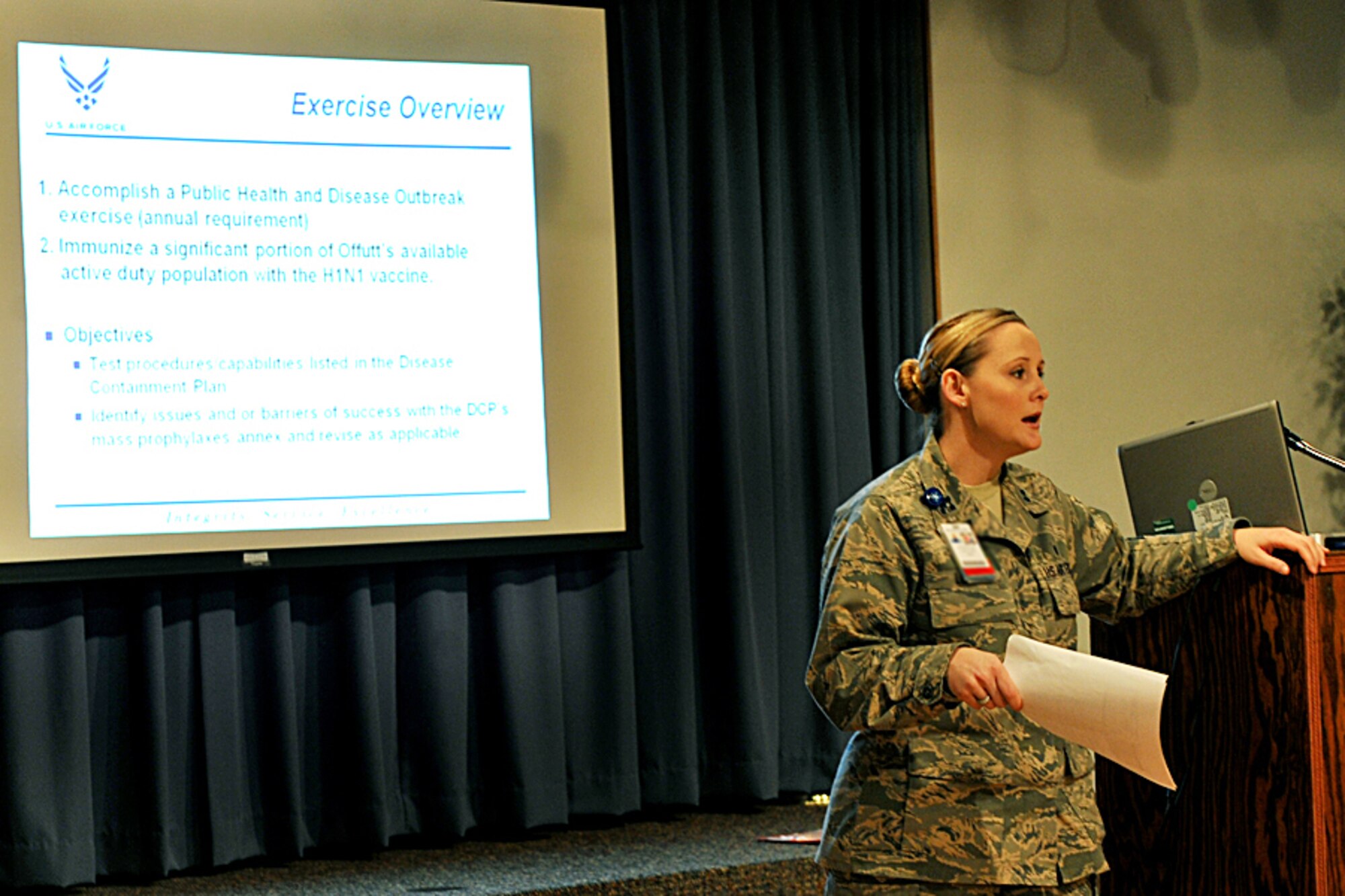 OFFUTT AIR FORCE BASE, Neb. - Capt. Marcie Lewis, with the 55th Medical Support Squadron, briefs members of Team Offutt on the disease containment plan during a Point of Distribution exercise Jan. 21 at the community center here. More than 1,000 active-duty personnel processed through the center to test the 55th Wing's ability to respond to a public health emergency.  Many received their H1N1 inoculation during the event. U.S. Air Force photo by Charles Haymond 

