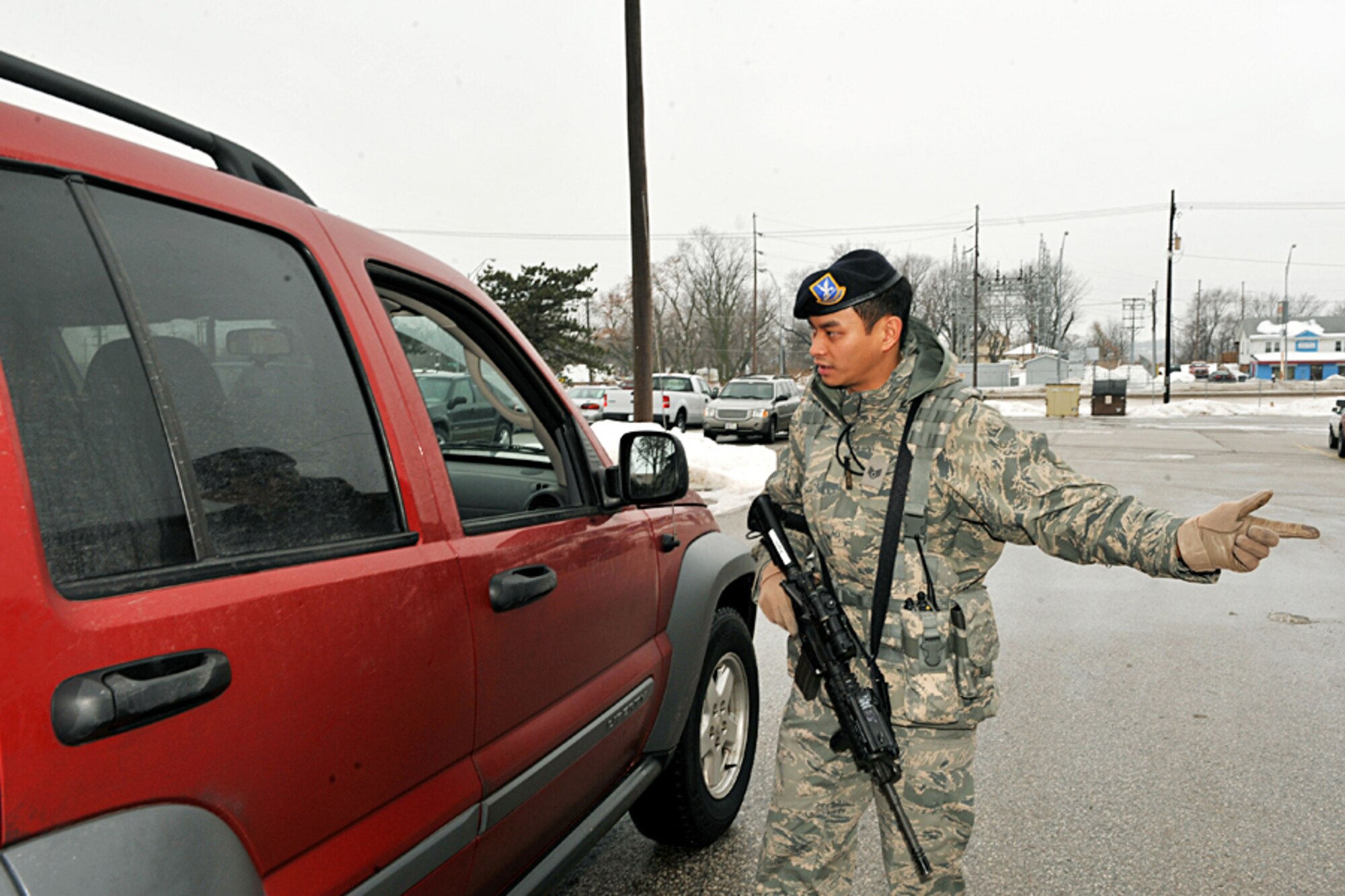 OFFUTT AIR FORCE BASE, Neb. - Staff Sgt. Ernie Argarin, with the 55th Security Forces Squadron, directs a driver at an entry control point near the community center here during a Point of Distribution exercise Jan. 21.  More than 1,000 active-duty personnel processed through the center to test the 55th Wing's ability to respond to a public health emergency.  Many received their H1N1 inoculation during the event.
U.S. Air Force photo by Charles Haymond
