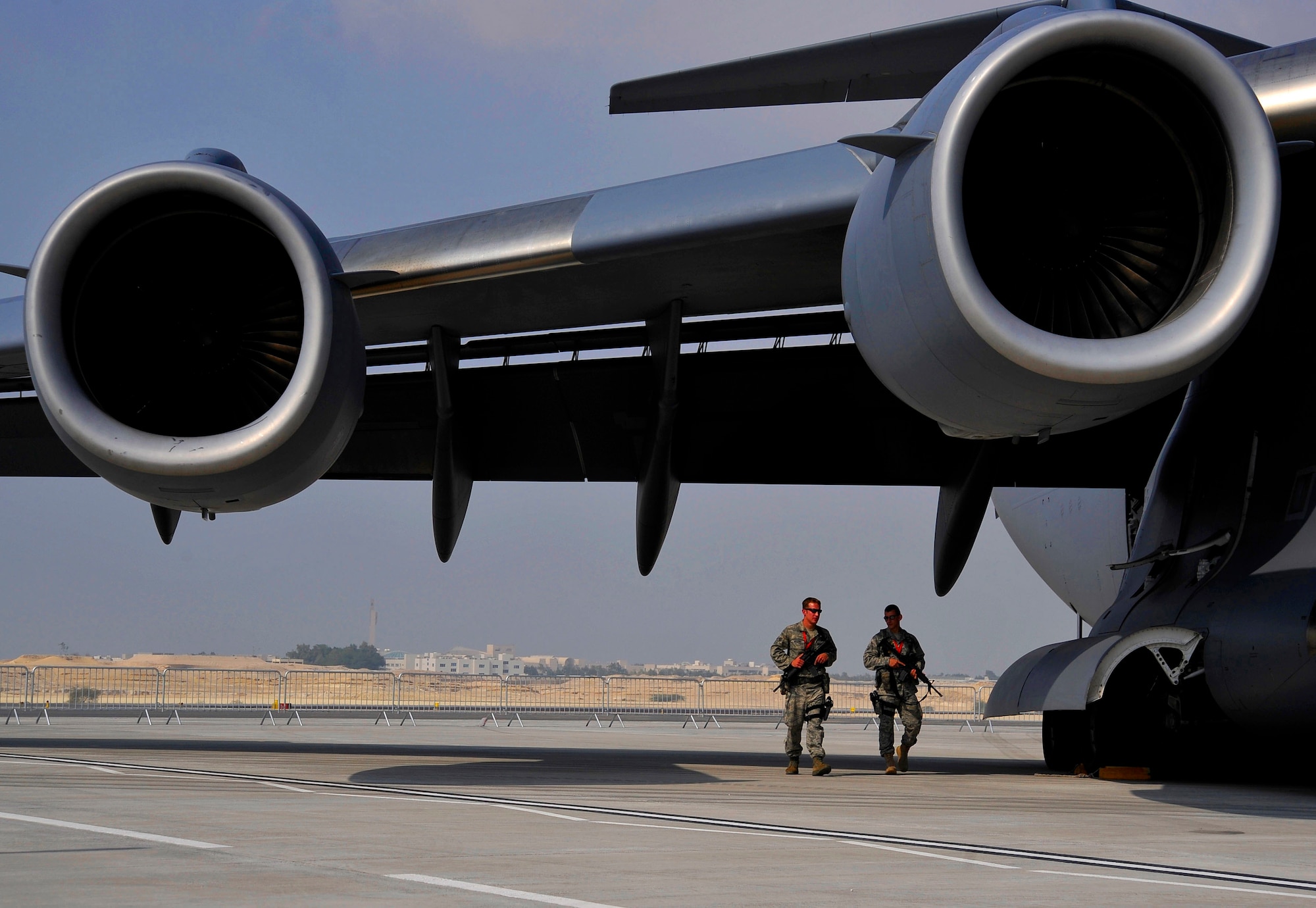 U.S. Air Force Airmen 1st Class Timothy Michaud and Brandon Denton, from the 20th Security Forces Squadron at Shaw Air Force Base, S.C., walk around a C-17 Globemaster III providing security during the inaugural Bahrain International Airshow, Jan. 22, 2010.   (U.S. Air Force photo/ Staff Sgt. Angelita Lawrence/released)
