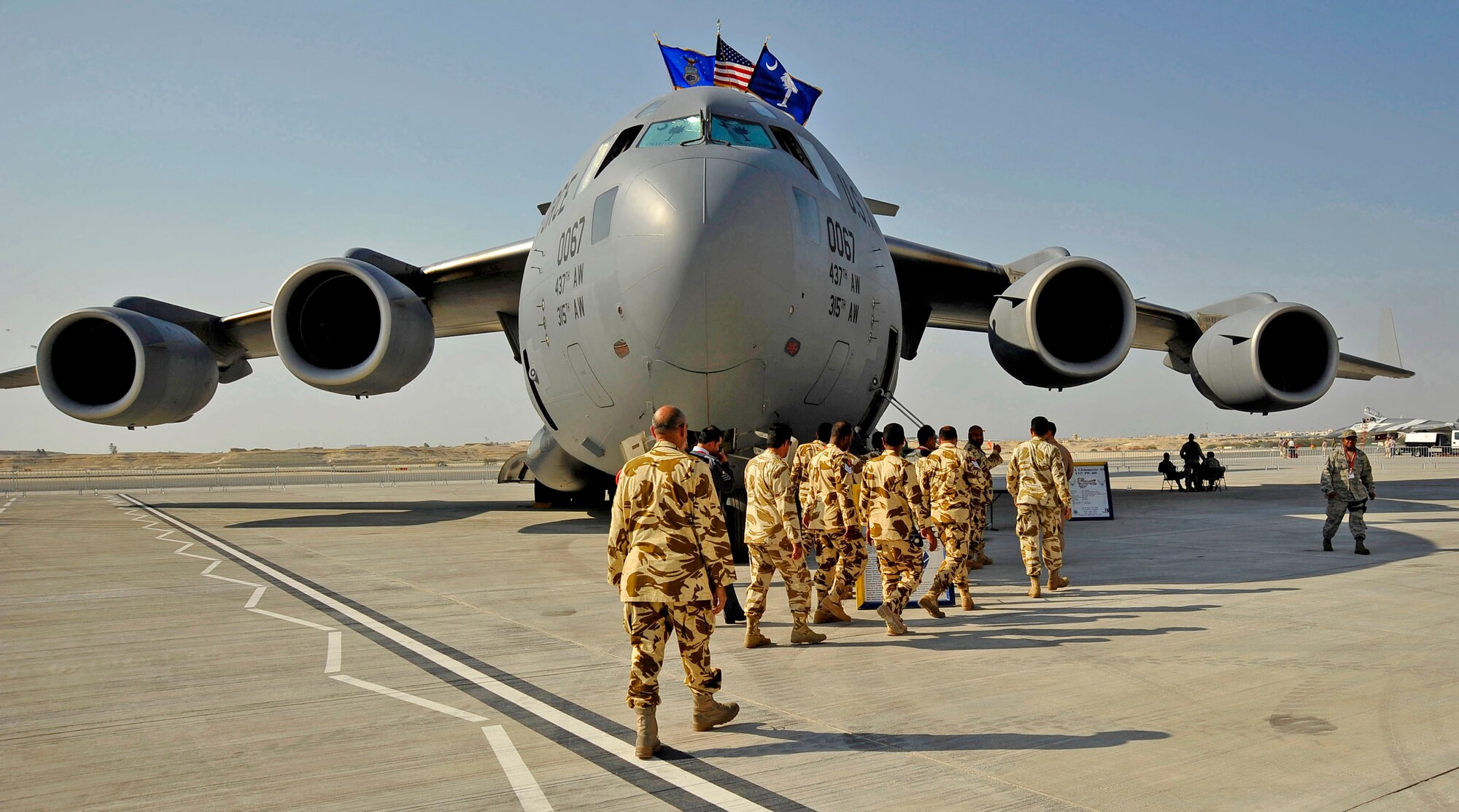 Airmen escort members of the Bahraini Royal Air Force onto a C-17 Globemaster III for a tour of the aircraft during the Bahrain International Airshow Jan. 21, 2010. (U.S. Air Force photo/Staff Sgt. Angelita Lawrence)