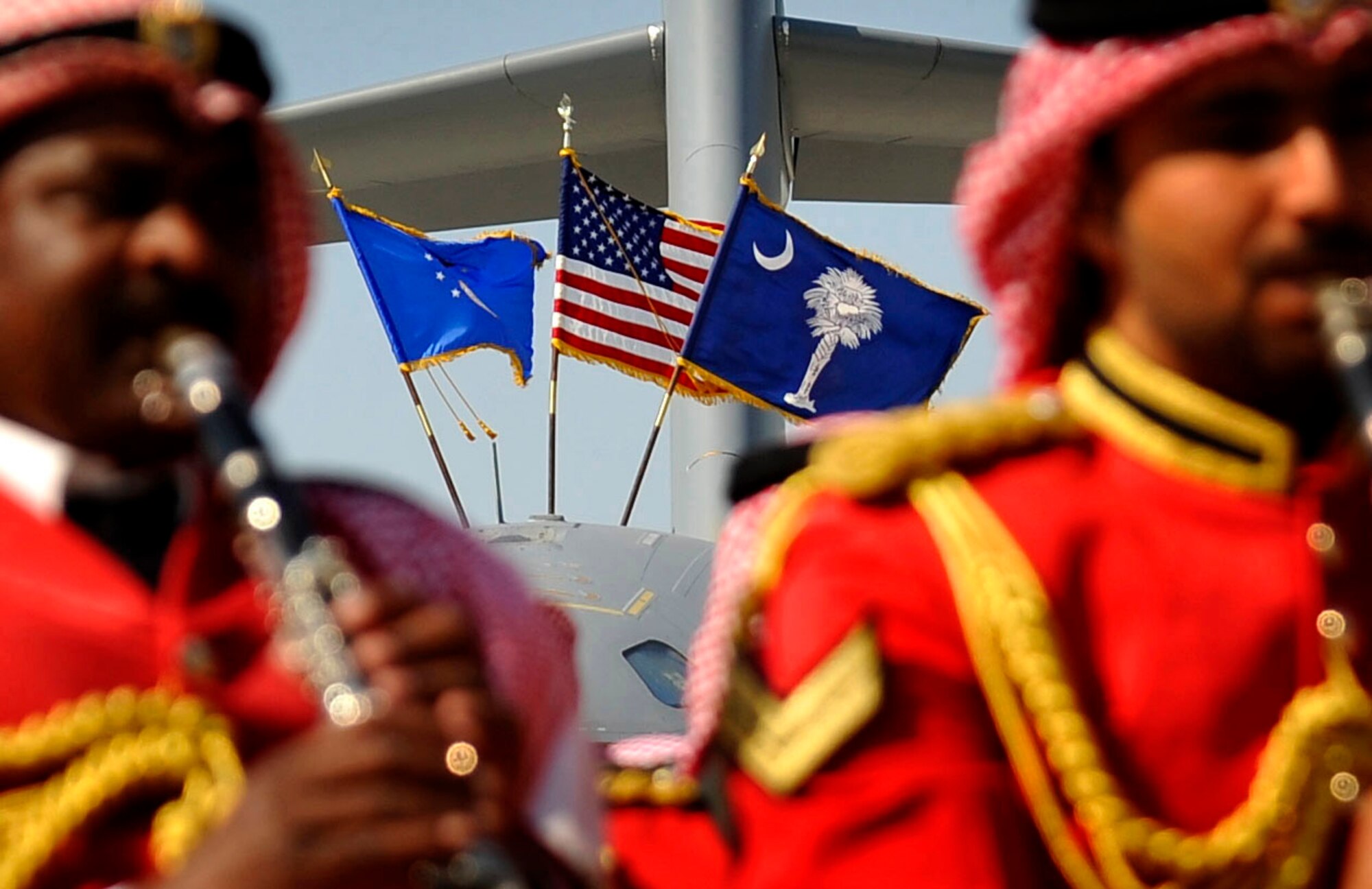 The U.S. flag, along with the Air Force and South Carolina state flag fly from on top of a C-17 Globemaster III while a Bahraini military band plays Jan. 21, 2010, at the Bahrain International Airshow. (U.S. Air Force photo/Staff Sgt. Angelita Lawrence) 
