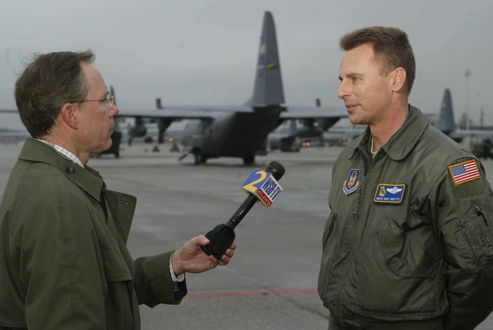 During an interview with a WSB-TV reporter, Senior Master Sgt. Dave Violette from the 700th Airlift Squadron discusses the roles he and his crew played during their support in the Haiti earthquake relief effort. The seven-member aircrew from the 700th Airlift Squadron deployed Jan. 17 and spent their time tranpsorting medical and communications teams to Florida and delivered food, water and fuel to the earthquake victims in Port-au-Prince, Haiti. They returned Jan. 21. (U.S. Air Force photo/Don Peek)