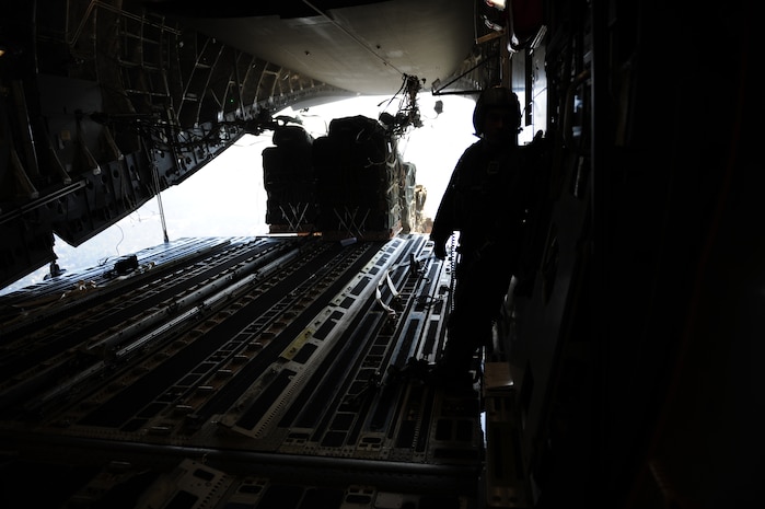 Container delivery system bundles exit a C-17 Globemaster III aircraft assigned to the 437th Airlift Wing, Charleston Air Force Base, S.C., during an air delivery mission over Haiti in support of Operation Unified Response Jan. 21, 2010. The aircrew, assigned to the 15th Airlift Squadron, Charleston AFB, S.C., delivered 40 container delivery system bundles totaling 67,800 pounds of Meals Ready to Eat and bottled water. (U.S. Air Force photo by Staff Sgt. Jacob N. Bailey / Released)