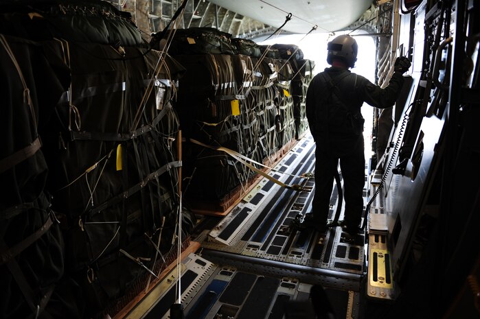Staff Sgt. Matthew Shields, a C-17 Globemaster III loadmaster assigned to the 15th Airlift Squadron, Charleston Air Force Base, S.C., awaits the green light during an air delivery mission over Haiti in support of Operation Unified Response Jan. 21, 2010. The crew delivered 40 container delivery system bundles totaling 67,800 pounds of Meals Ready to Eat and bottled water. (U.S. Air Force photo by Staff Sgt. Jacob N. Bailey / Released)