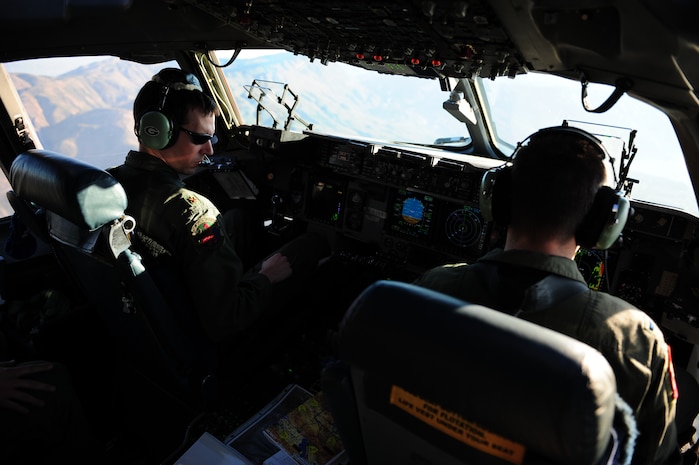 U.S. Air Force Maj. Jason Kirkland, left, and 1st Lt. David Redwine, C-17 Globemaster III pilots assigned to the 15th Airlift Squadron, Charleston Air Force Base, S.C., approach a drop zone over Haiti during an air delivery mission in support of Operation Unified Response Jan. 21, 2010. The mission was the second air delivery flown to Haiti since relief operations began. (U.S. Air Force photo by Staff Sgt. Jacob N. Bailey/Released)