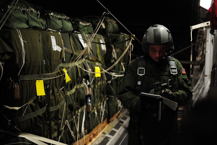 Staff Sgt. Matthew Shields, a C-17 Globemaster III loadmaster assigned to the 15th Airlift Squadron, Charleston Air Force Base, S.C., conducts in-flight checklists during an air delivery mission in support of Operation Unified Response Jan. 21, 2010. The crew delivered 40 container delivery system bundles totaling 67,800 pounds of Meals Ready to Eat and bottled water. (U.S. Air Force photo by Staff Sgt. Jacob N. Bailey / Released)