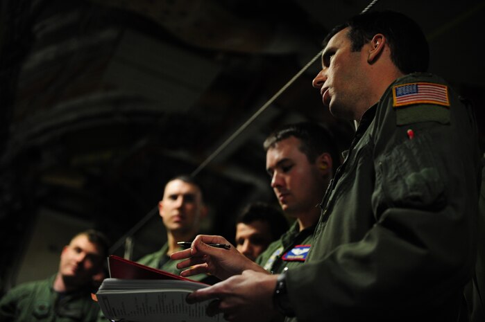 U.S. Air Force Maj. Jason Kirkland, right, a C-17 Globemaster III pilot assigned to the 15th Airlift Squadron, Charleston Air Force Base, S.C., briefs his fellow aircrew members prior to an air delivery mission in support of Operation Unified Response, Jan. 21, 2010. The mission was the second air delivery flown to Haiti since relief operations began. (U.S. Air Force photo by Staff Sgt. Jacob N. Bailey / Released)