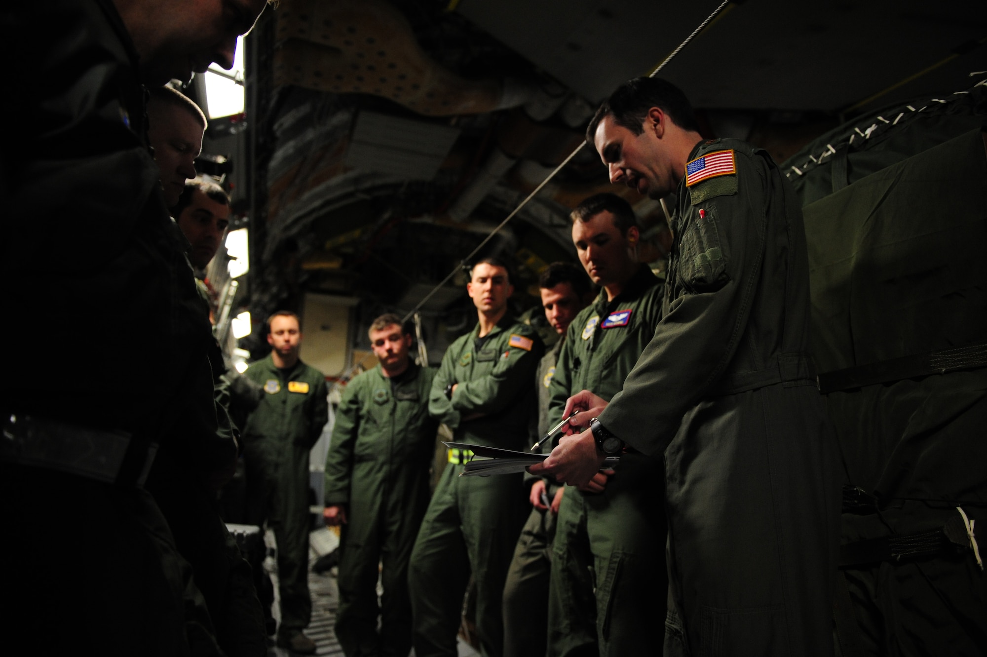 U.S. Air Force Maj. Jason Kirkland, right, a C-17 Globemaster III pilot assigned to the 15th Airlift Squadron, Charleston Air Force Base, S.C., briefs his fellow aircrew members prior to an air delivery mission in support of Operation Unified Response Jan. 21, 2010. The mission was the second air delivery flown to Haiti since relief operations began. (U.S. Air Force photo by Staff Sgt. Jacob N. Bailey / Released)