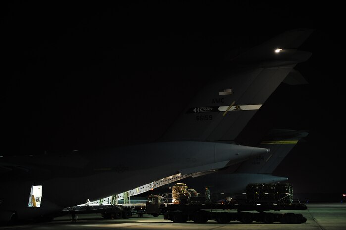 U.S. Air Force Airmen assigned to the 43rd Logistical Readiness Squadron, Pope Air Force Base, N.C., load a C-17 Globemaster III  from Travis Air Force Base as a backup aircraft for an air delivery mission in support of Operation Unified Response Jan. 21, 2010. (U.S. Air Force photo by Staff Sgt. Jacob N. Bailey / Released)