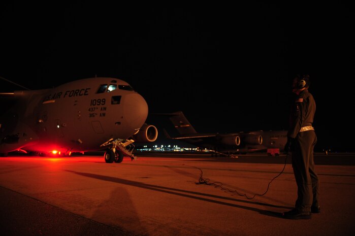 U.S. Air Force 1st Lt. David Redwine, a C-17 Globemaster III pilot assigned to the 15th Airlift Squadron, Charleston Air Force Base, S.C., monitors aircraft engines startup before launching on an air delivery mission from Charleston AFB in support of Operation Unified Response Jan. 20, 2010. The mission was the second air delivery flown to Haiti since relief operations began. (U.S. Air Force photo by Staff Sgt. Jacob N. Bailey / Released)
