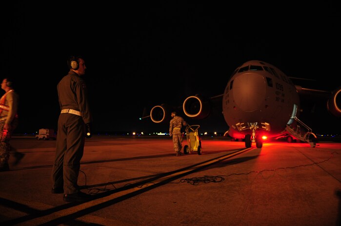 U.S. Air Force 1st Lt. David Redwine, a C-17 Globemaster III pilot assigned to the 15th Airlift Squadron, Charleston Air Force Base, S.C., monitors aircraft engines startup before launching on an air delivery mission from Charleston AFB in support of Operation Unified Response Jan. 20, 2010. The mission was the second air delivery flown to Haiti since relief operations began. (U.S. Air Force photo by Staff Sgt. Jacob N. Bailey / Released)