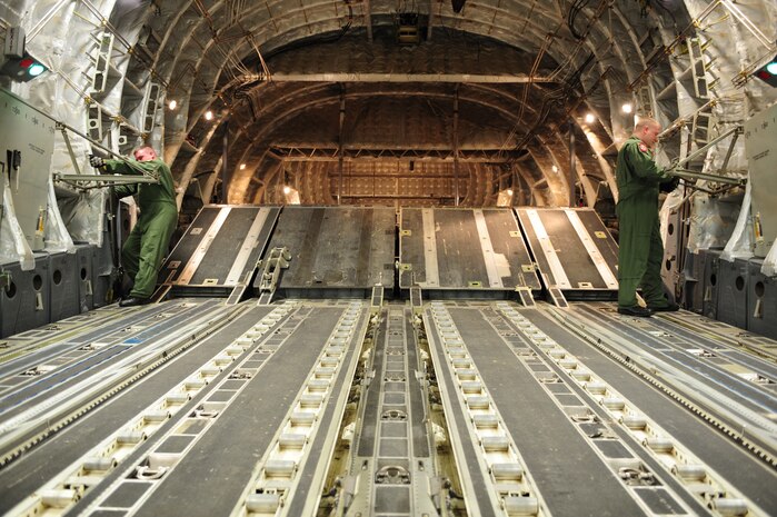 U.S. Air Force Senior Airman Mike Solly, right, and Staff Sgt. Matthew Shields, C-17 Globemaster III loadmasters assigned to the 15th Airlift Squadron, Charleston Air Force Base, S.C., prepare an aircraft configuration before an air delivery mission in support of Operation Unified Response here at Charleston AFB, S.C., Jan. 20, 2010. The mission was the second air delivery flown to Haiti since relief operations began. (U.S. Air Force photo by Staff Sgt. Jacob N. Bailey / Released)