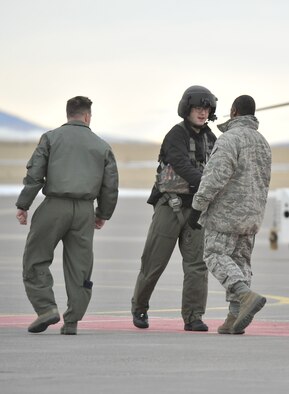 Senior Airman Kyle Meck, 40th Helicopter Squadron flight engineer, greets Brig. Gen. Jimmy McMillian, HQ USAF/A7S, prior to boarding a helicopter for a tour at India Missile Alert Facility Jan. 15. Lt. Col. Timothy Zachirias, 40th HS commander, is at the left. (U.S. Air Force photo/John Turner)