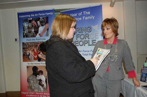 Staci Corder, right, 341st Force Support Squadron marketing director, talks with Malmstrom spouse Tina Penny, about Year of the Air Force Family initiatives and upcoming events prior to the start of the  Spouse's Call briefing at the base theater Jan. 14. (U.S. Air Force photo/Valerie Mullett)