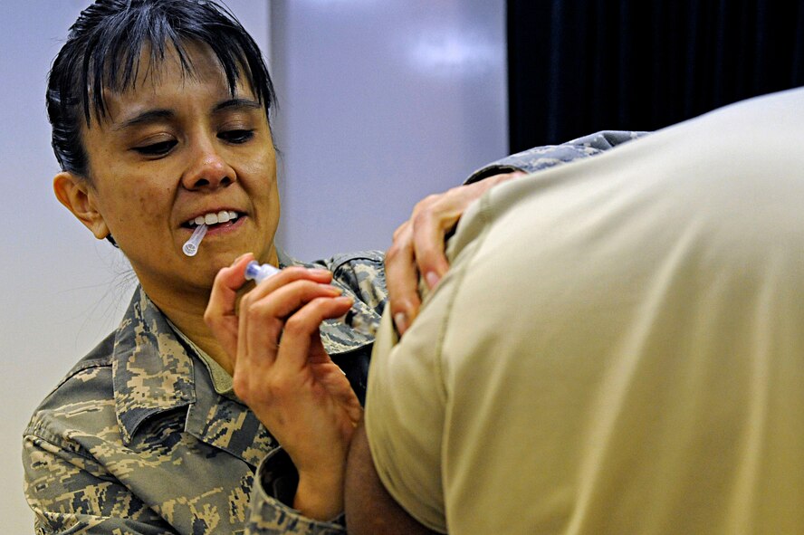 Master Sgt. Diane Ramirez, 28th Medical Operations Squadron flight medicine NCO in charge, administers the H1N1 flu shot to a member of the 28th Bomb Wing staff, Jan. 20. The vaccination is mandatory for all military members and can be received at the immunizations office Monday through Friday, 7:30 a.m. to 4 p.m.  (U.S. Air Force photo/Airman 1st Class Matthew Flynn)