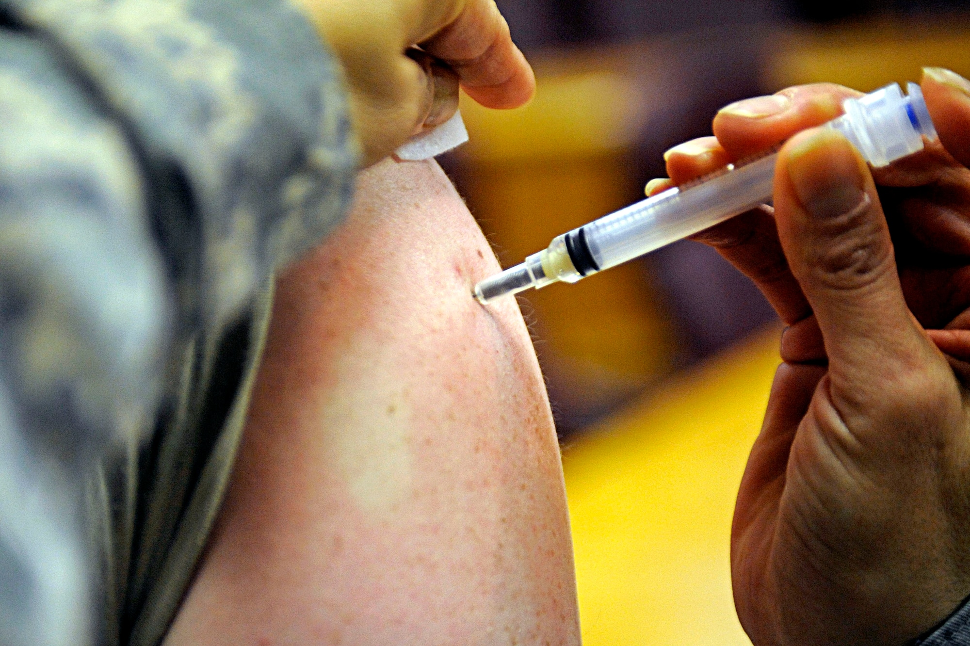 Master Sgt. Diane Ramirez, 28th Medical Operations Squadron flight medicine NCO in charge, administers an H1N1 flu shot to a member of the 28th Bomb Wing staff, Jan. 20. The vaccination is mandatory for all military members and can be received at the immunizations office Monday through Friday, 7:30 a.m. to 4 p.m. (U.S. Air Force photo/Airman 1st Class Matthew Flynn)