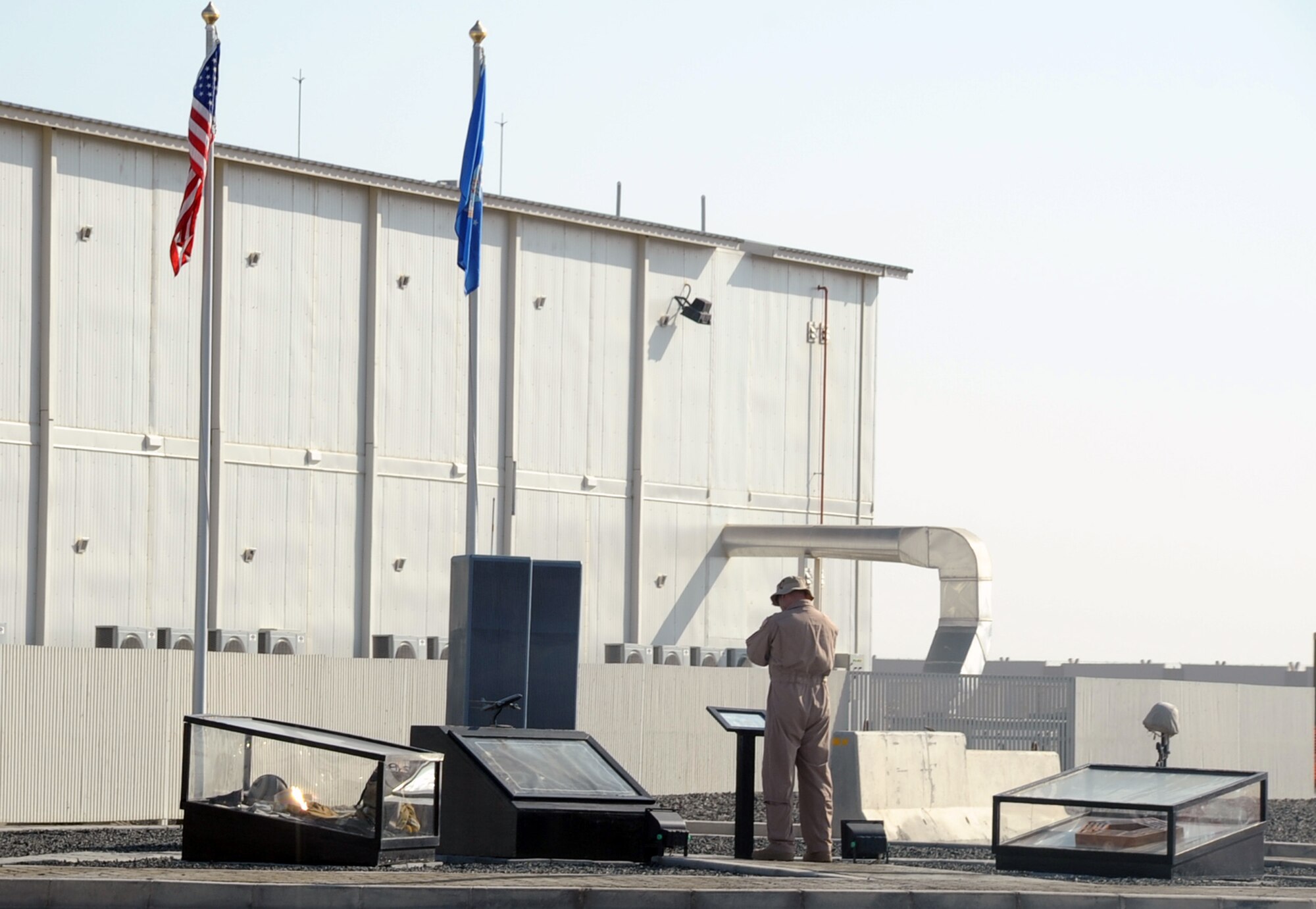 An Airman assigned to the 380th Air Expeditionary Wing reads a placard at the Sept. 11, 2001, memorial at a non-disclosed location in Southwest Asia. Every day, Airmen from the wing visit the memorial that honors the victims of that day.  (U.S. Air Force Photo/Tech. Sgt. Scott T. Sturkol/Released)