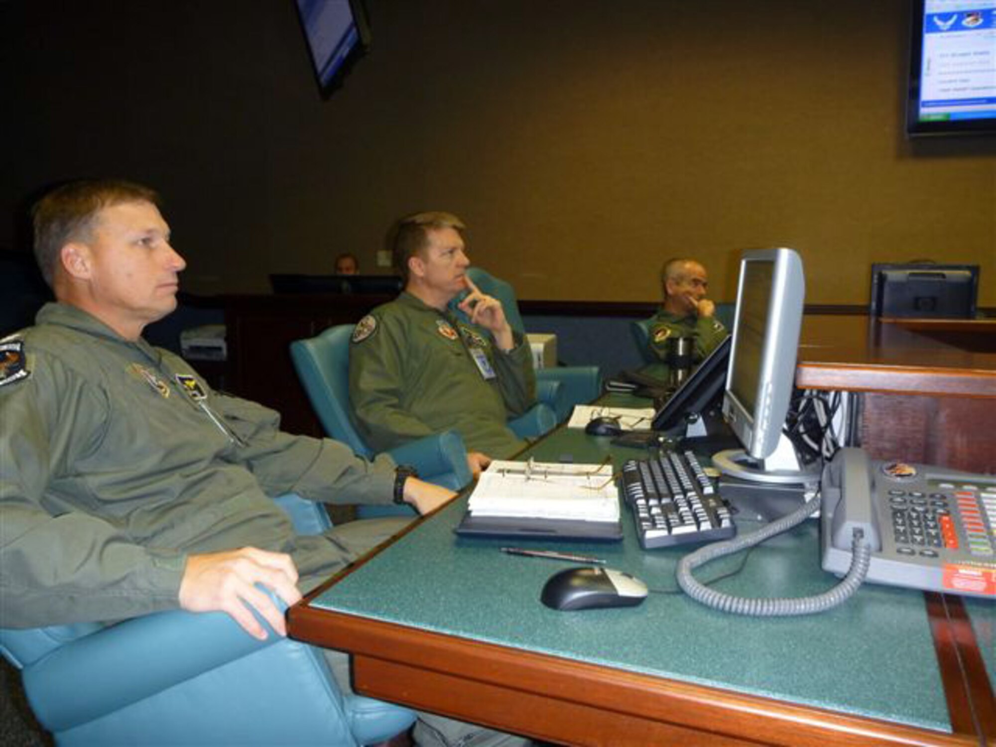 Air Force Col. Randall Spear, second from left, talks with members of the Haitian Flight Operations Coordination Center. Spear is commander of the Florida Air National Guard's 101st Air and Space Operations Group, which has been working since Jan. 15, 2010 with the Federal Aviation Administration and U.S. Southern Command to coordinate the flow of traffic into Haiti. (Photo by Lt. Col. Ron Tittle, Florida National Guard)