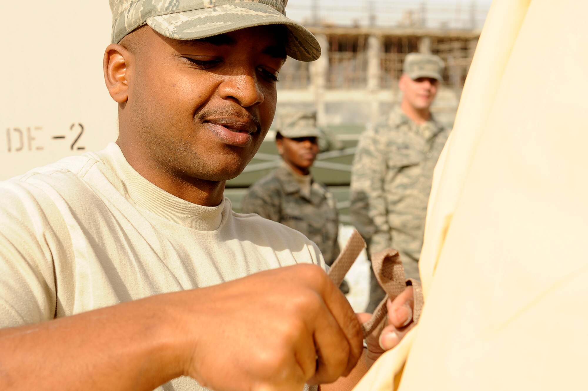 BAGRAM AIRFIELD, Afghanistan--U.S. Air Force Staff Sgt. Thomas Claybrooks, 455th Expeditionary Force Support Squadron, ties the ends of a tent together on Bagram Airfield, Jan. 19, 2010. Claybrooks is deployed from Moody Air Force Base, Ga., and is from Nashville, Tenn. (U.S. Air Force photo by: Tech. Sgt. Jeromy K. Cross/released)