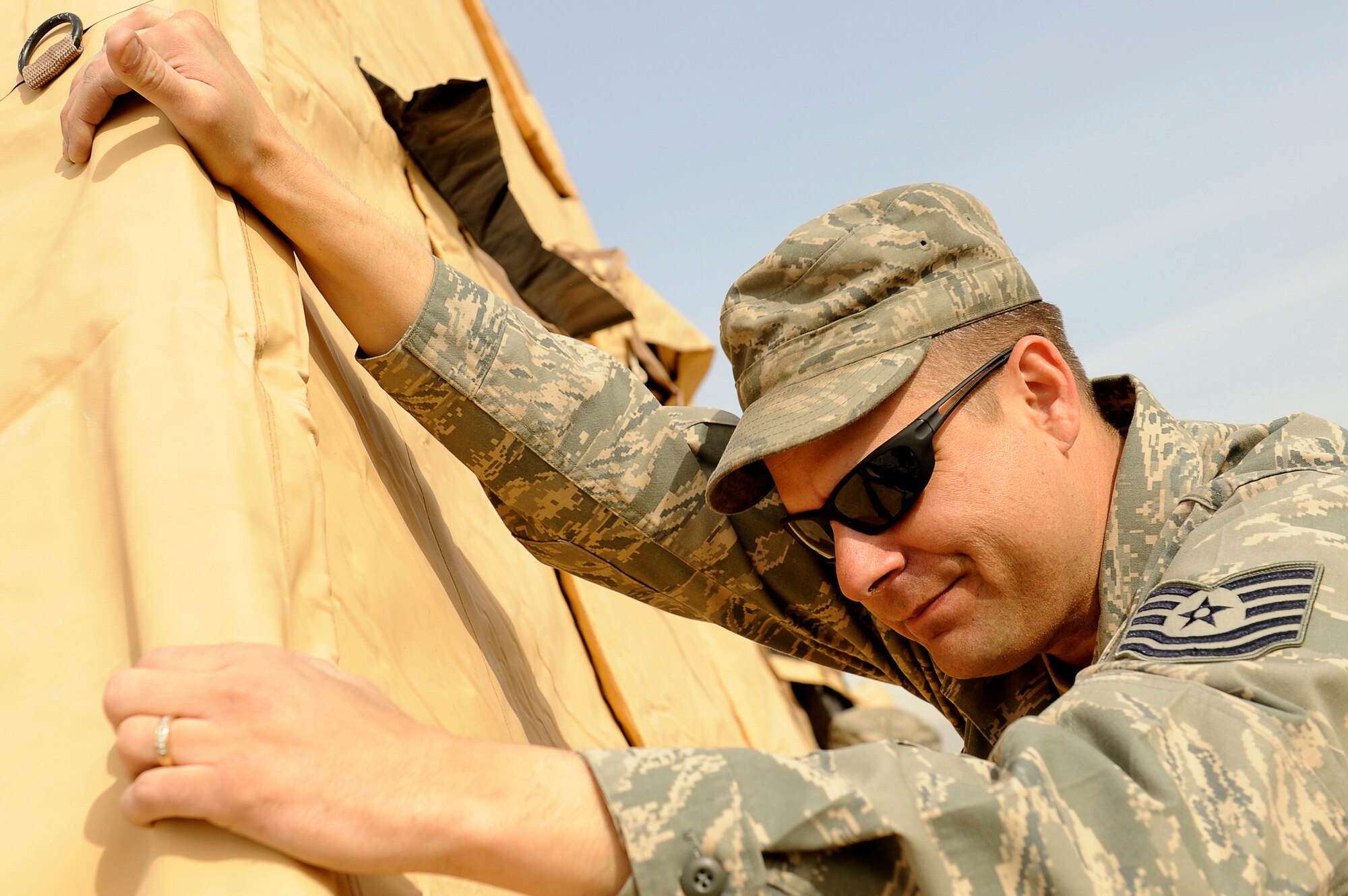 BAGRAM AIRFIELD, Afghanistan--U.S. Air Force Tech. Sgt. Jon Stewart, 455th Expeditionary Force Support Squadron, constructs a tent on Bagram Airfield, Jan. 19, 2010. Stewart is deployed from Elmendorf Air Force Base, Alaska, and is from San Antonio, Texas. (U.S. Air Force photo by: Tech. Sgt. Jeromy K. Cross/released)