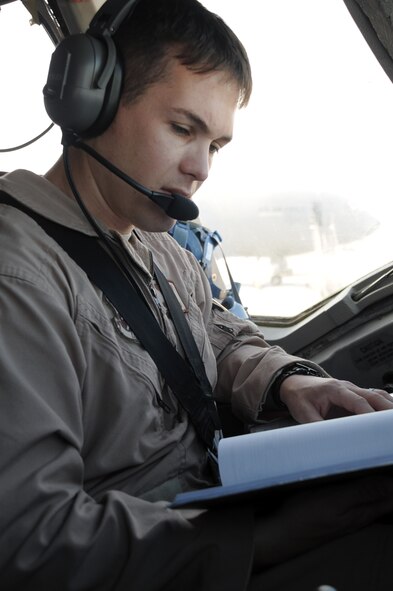 Capt. Wes Spurlock, KC-10 Extender pilot with the 908th Expeditionary Air Refueling Squadron at a non-disclosed location in Southwest Asia, runs through a checklist while preparing a KC-10 for a combat air refueling mission Jan. 22, 2010. Captain Spurlock is a 10-year veteran and  in his deployed duties drives the biggest air refueling aircraft in the Air Force inventory for combat air refueling missions in support of Operations Iraqi Freedom and Enduring Freedom and the Combined Joint Task Force-Horn of Africa. Captain Spurlock is deployed from Travis Air Force Base, Calif., and his hometown is Norco, Calif. (U.S. Air Force Photo/Tech. Sgt. Scott T. Sturkol/Released) 