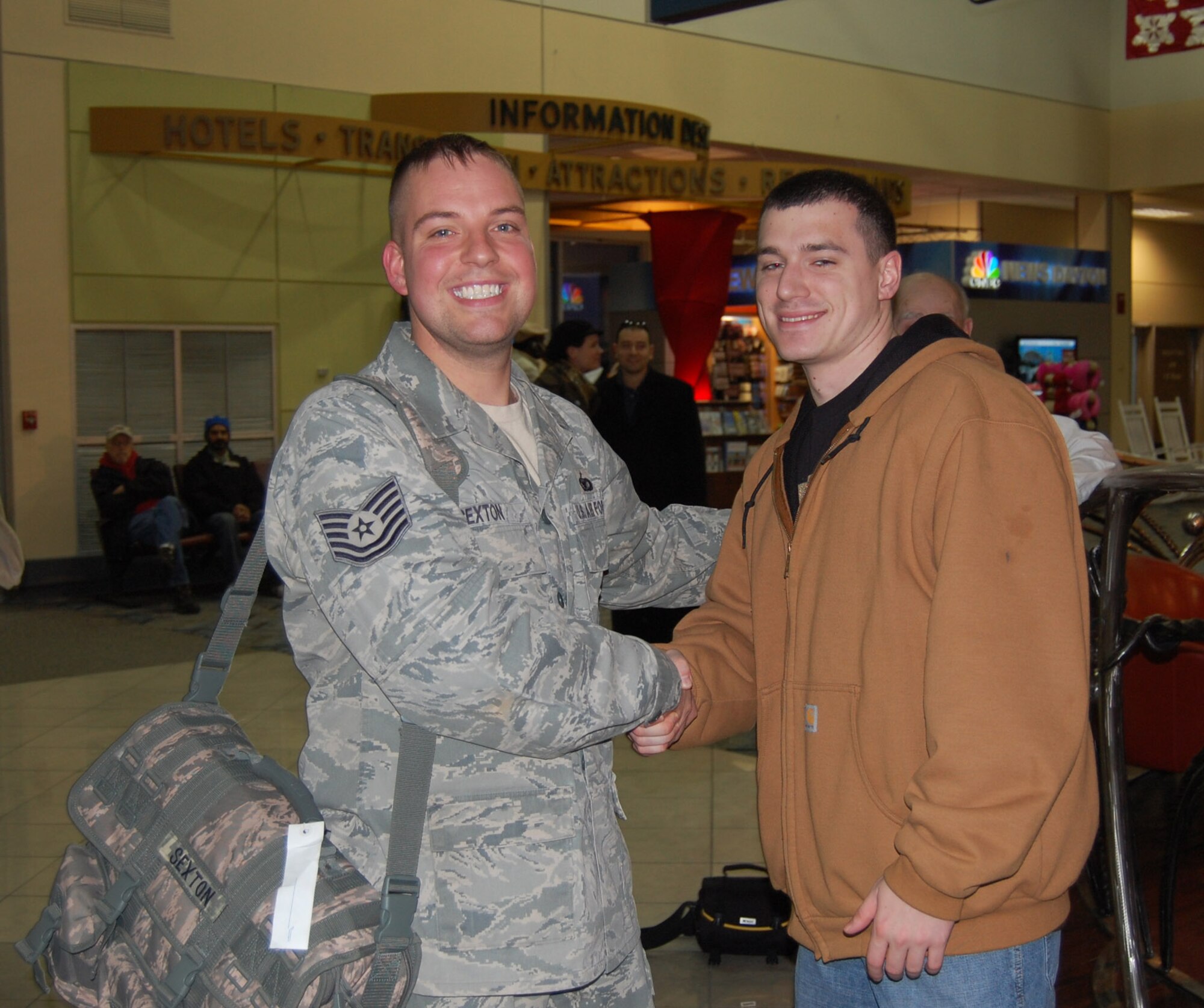 WRIGHT-PATTERSON AIR FORCE BASE, Ohio – Tech. Sgt. Tom Sexton, 445th Security Forces Squadron, is greeted by his best friend, Senior Airman Bray Schulte, also from the 445th SFS, at the Dayton International Airport Jan. 17.  Sergeant Sexton and 12 other members from his unit completed a 197-day deployment in Kirkuk, Iraq. While deployed the Airmen performed various security forces functions to include base security, vehicle searches, gate security, patrol, and tower duties. (U.S. Air Force photo/Maj. Cynthia Harris)