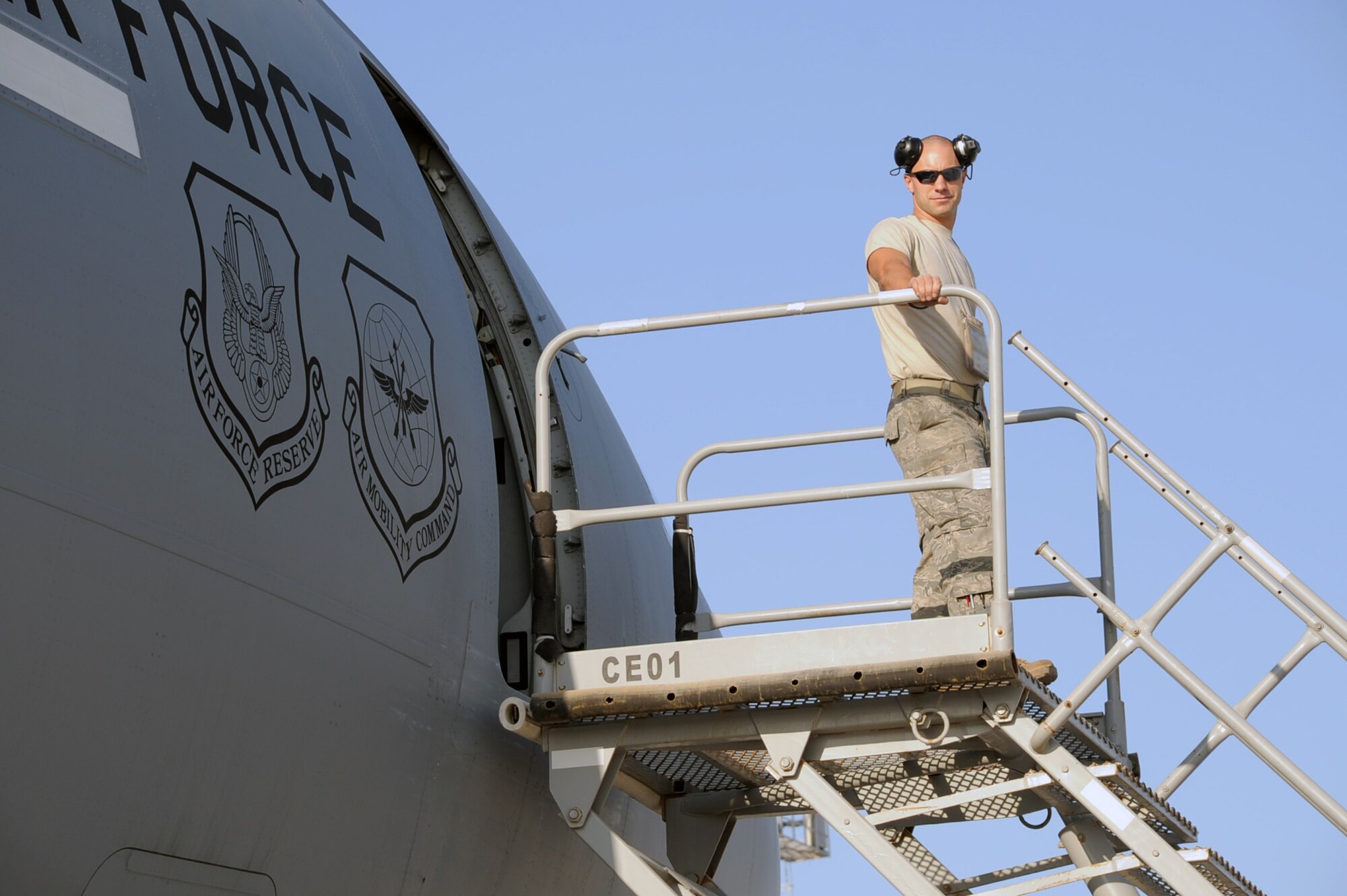 Staff Sgt. Grant Ciccone, a KC-10 Extender crew chief with the 380th Aircraft Maintenance Squadron deployed from the 605th AMXS of Joint Base McGuire-Dix-Lakehurst, N.J., stands atop air stairs in between his work in preparing a KC-10 for a mission during operations on the flightline at a nin-disclosed base in Southwest Asia on Jan. 22, 2009. KC-10s at this deployed location, assigned to the 908th Expeditionary Air Refueling Squadron with some also deployed from Joint Base M-D-L, are one of Air Mobility Command's air refueling aircraft deployed to the U.S. Central Command area of responsibility that provides the "global reach" for Air Force and Department of Defense aircraft through air refueling operations for Operations Iraqi Freedom and Enduring Freedom and the Combined Joint Task Force-Horn of Africa. (U.S. Air Force Photo/Tech. Sgt. Scott T. Sturkol/Released)