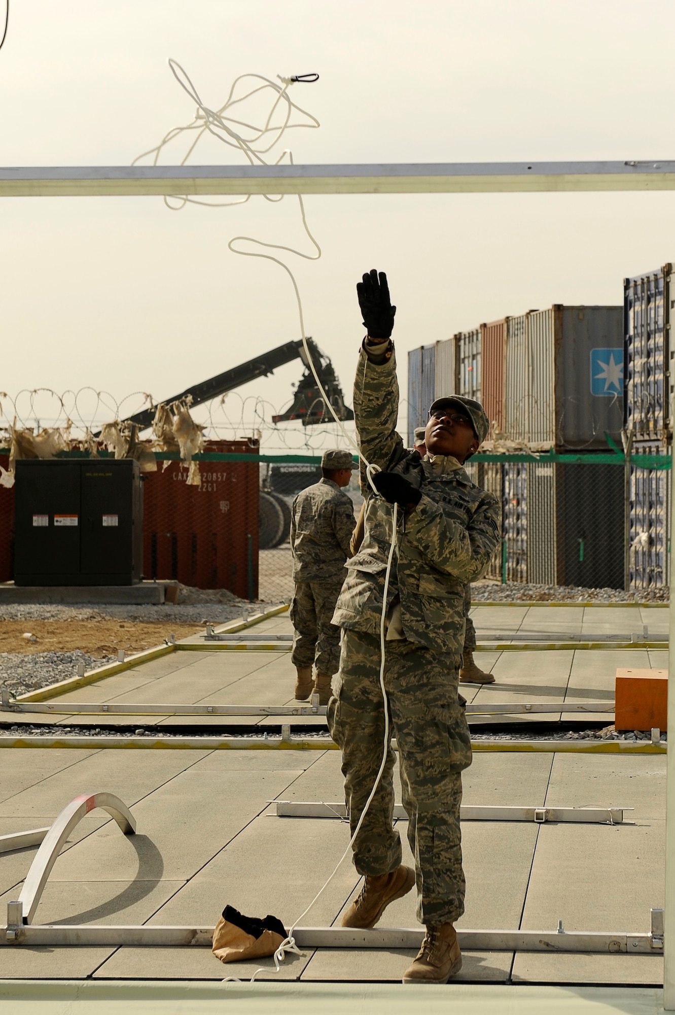 BAGRAM AIRFIELD, Afghanistan--U.S. Air Force Senior Airman Jessica Jackson, 455th Expeditionary Force Support Squadron, throws a line over a frame while constructing tents on Bagram Airfield, Jan. 19, 2010. Jackson is deployed from Moody Air Force Base, Ga., and is from Kenbridge, Va. (U.S. Air Force photo by: Tech. Sgt. Jeromy K. Cross/released)

