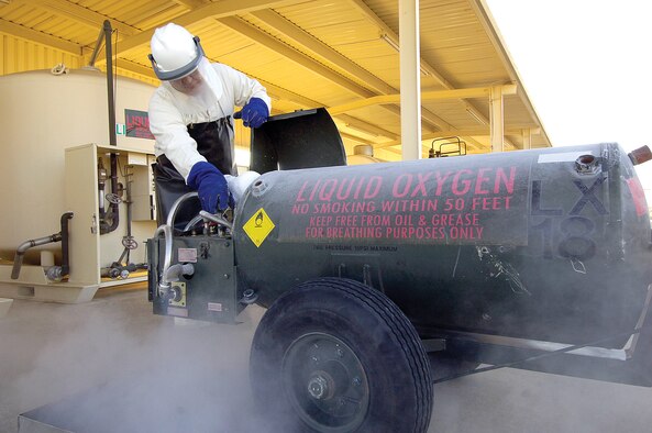 Fuels specialist Ken Gambill, 72nd Logistics Readiness Squadron’s Base Fuels Quality Assurance Office, carefully monitors the refilling of liquid oxygen into a portable tank that will be used by an aircraft’s crew for breathing oxygen. The liquid oxygen turns to a gas at -297 degrees so protective gear is vital. The fog seen is bleed-off of the super cooled gas. The Fuels Management Flight handles aviation fuel for all customers on Tinker as well as liquid oxygen, CNG, vehicle fuels and de-icing fluid. (Air Force photos by Margo Wright)