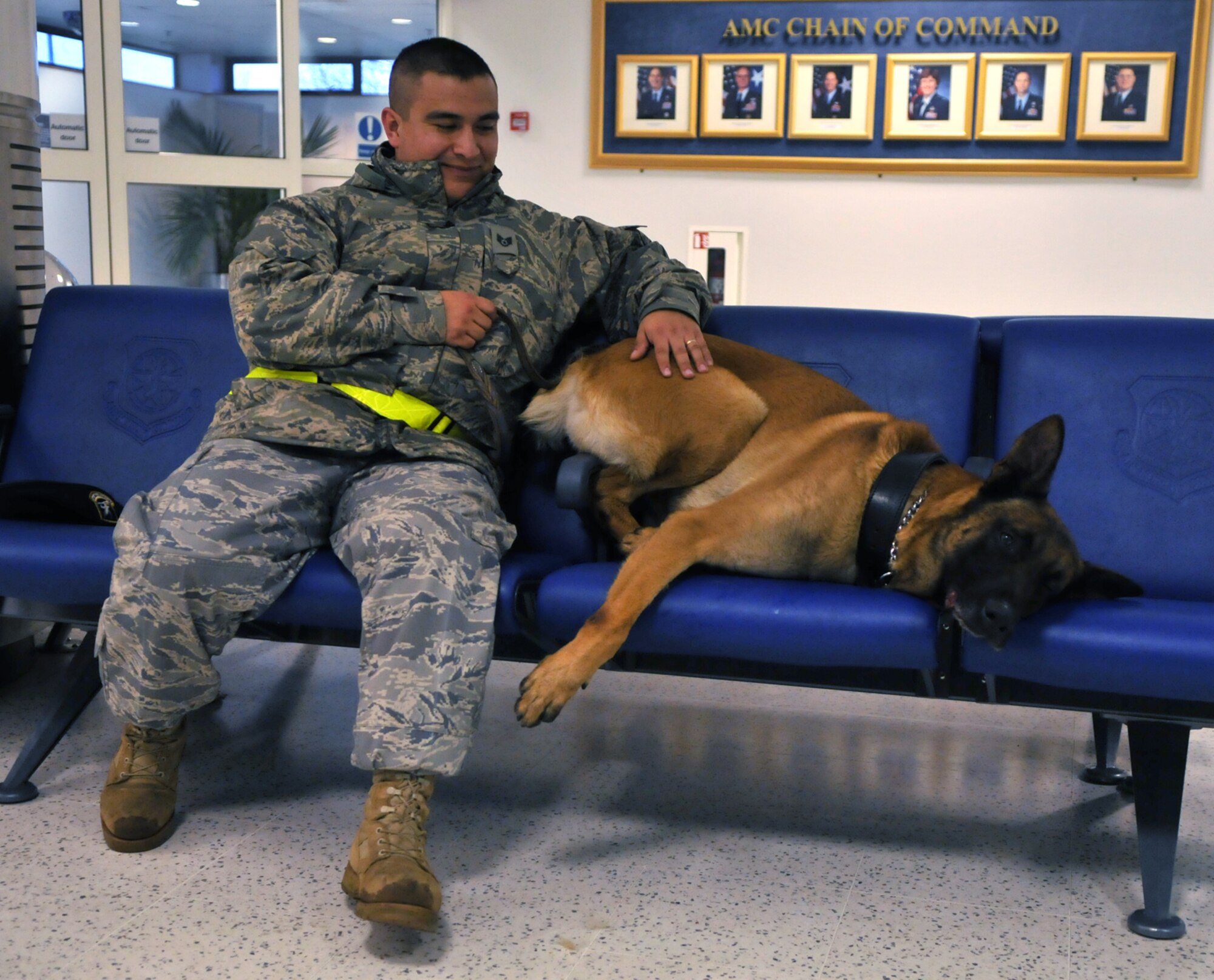 RAF MILDENHALL, England -- Ootto, a 5-year-old Belgian Malinois, takes a quick break with his handler, Staff Sgt. Eric Morales, 100th Security Forces Squadron, after sniffing around the base passenger terminal Jan. 22 in preparation for the arrival of Vice President Joe Biden.  (U.S. Air Force photo by Staff Sgt. Austin M. May)