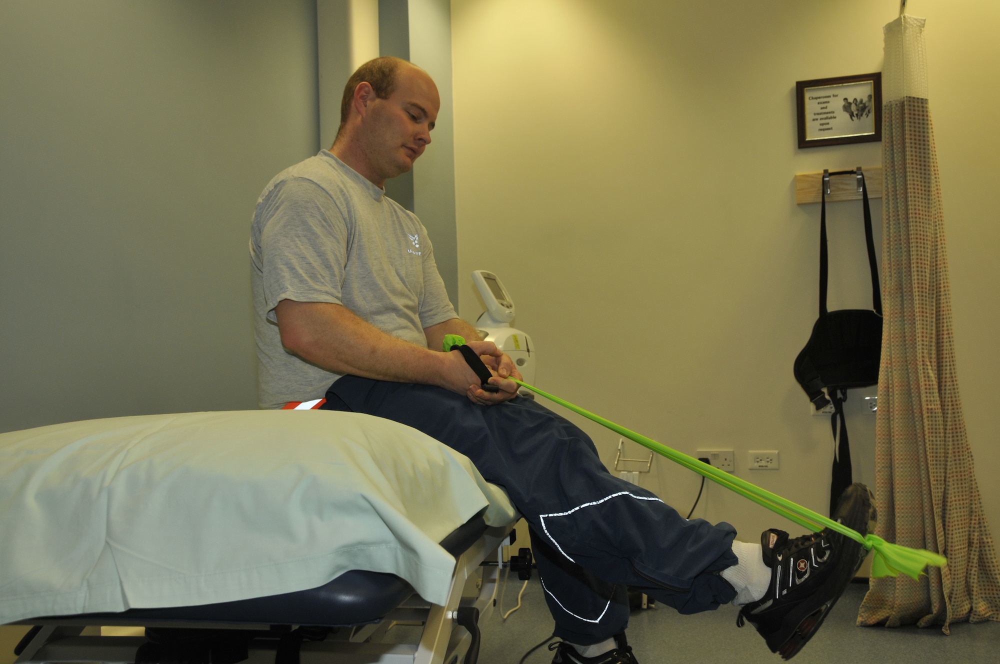Senior Airman Robert Denby, 48th Munitions Squadron munitions systems crew chief, stretches with bands after a work out to help with nerve problems in his ankles at RAF Lakenheath, England Dec. 3. Patients come to occupational and physical therapy for a wide range of problems and each patient has a unique path to recovery. (U.S. Air Force photo Airman 1st Class Eboni Knox) 