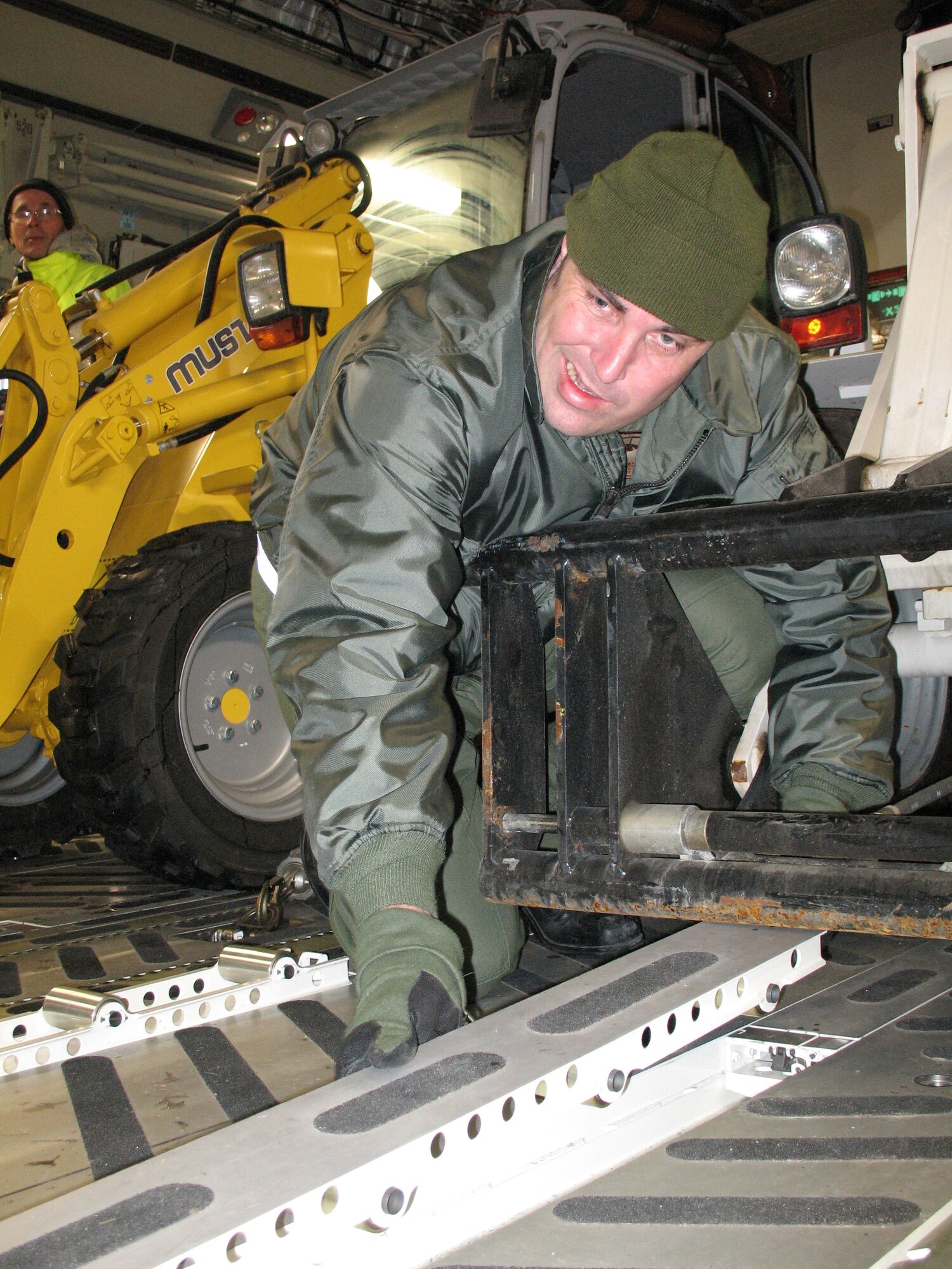 The Netherlands Air Force Master Sgt. Marcel Boeija, a loadmaster with the Heavy Airlift Wing, Papa Air Base, Hungary, reconfigures a C-17 transport aircraft on Jan. 20 to load aid materials and equipment bound for Haiti.  The aircraft and its multi-national aircrew were preparing for a second mission from Orebro Sweden. The crew had previously delivered 15 pallets of material to construct a headquarters for aid workers at the Port-au-Prince, Haiti airport on Jan. 18. in response to the massive earthquake that struck Haiti Jan. 12. This is the first humanitarian assistance operation flown by the Heavy Airlift Wing since it stood up in July 2009.  The wing is a multi-national force made up of Airmen from 12 nations.  (U.S. Air Force photo by Staff Sgt. Michael T. McCool)  